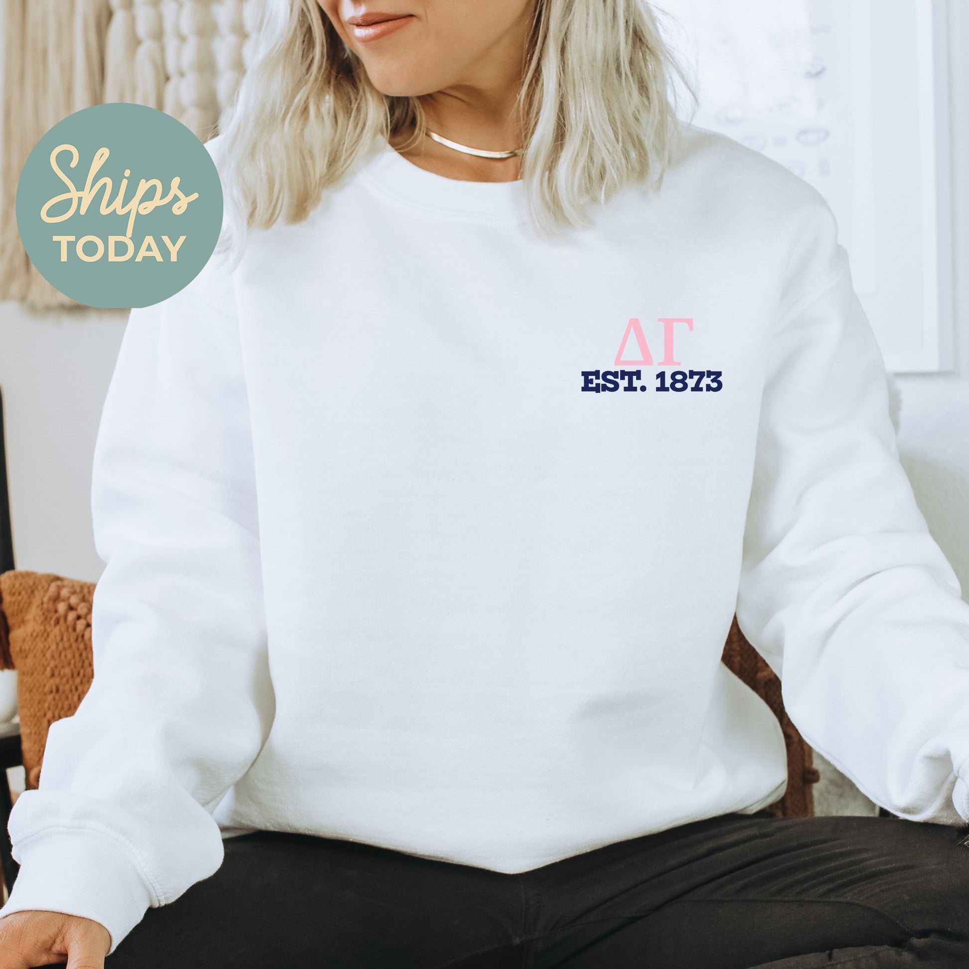 a woman sitting on a chair wearing a white sweatshirt