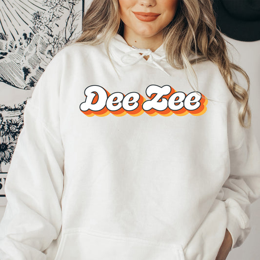 a woman wearing a white hoodie with the word dee zee on it