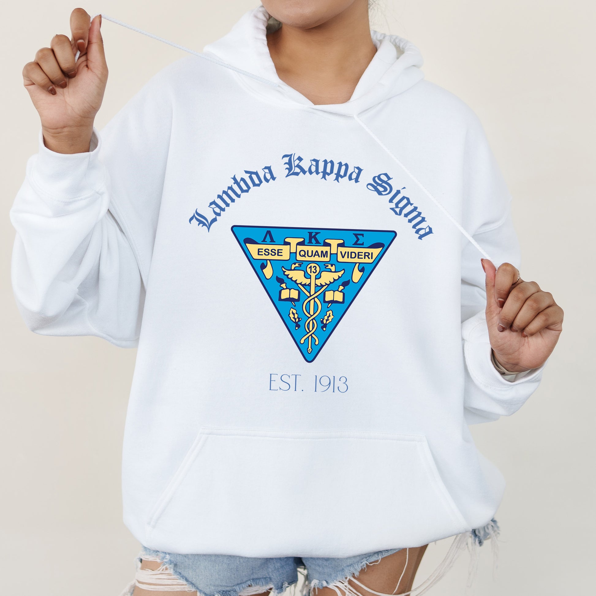 a woman in a white hoodie holding a toothbrush