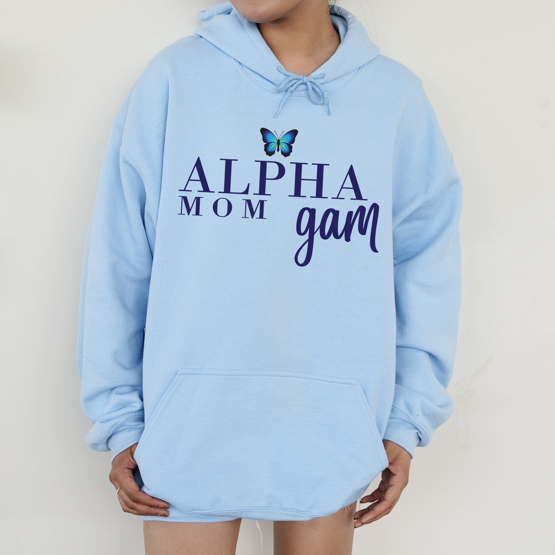 a young girl wearing a blue hoodie with the words, alpha mom gam