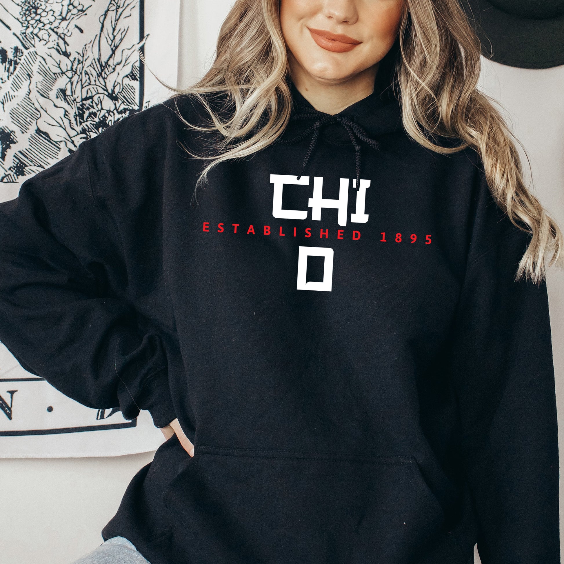 a woman wearing a black hoodie with the letters chl on it
