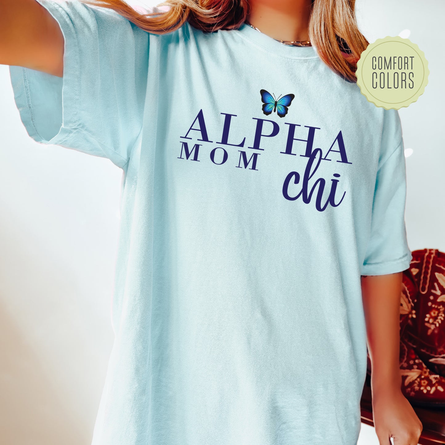 a woman wearing a blue shirt with a butterfly on it