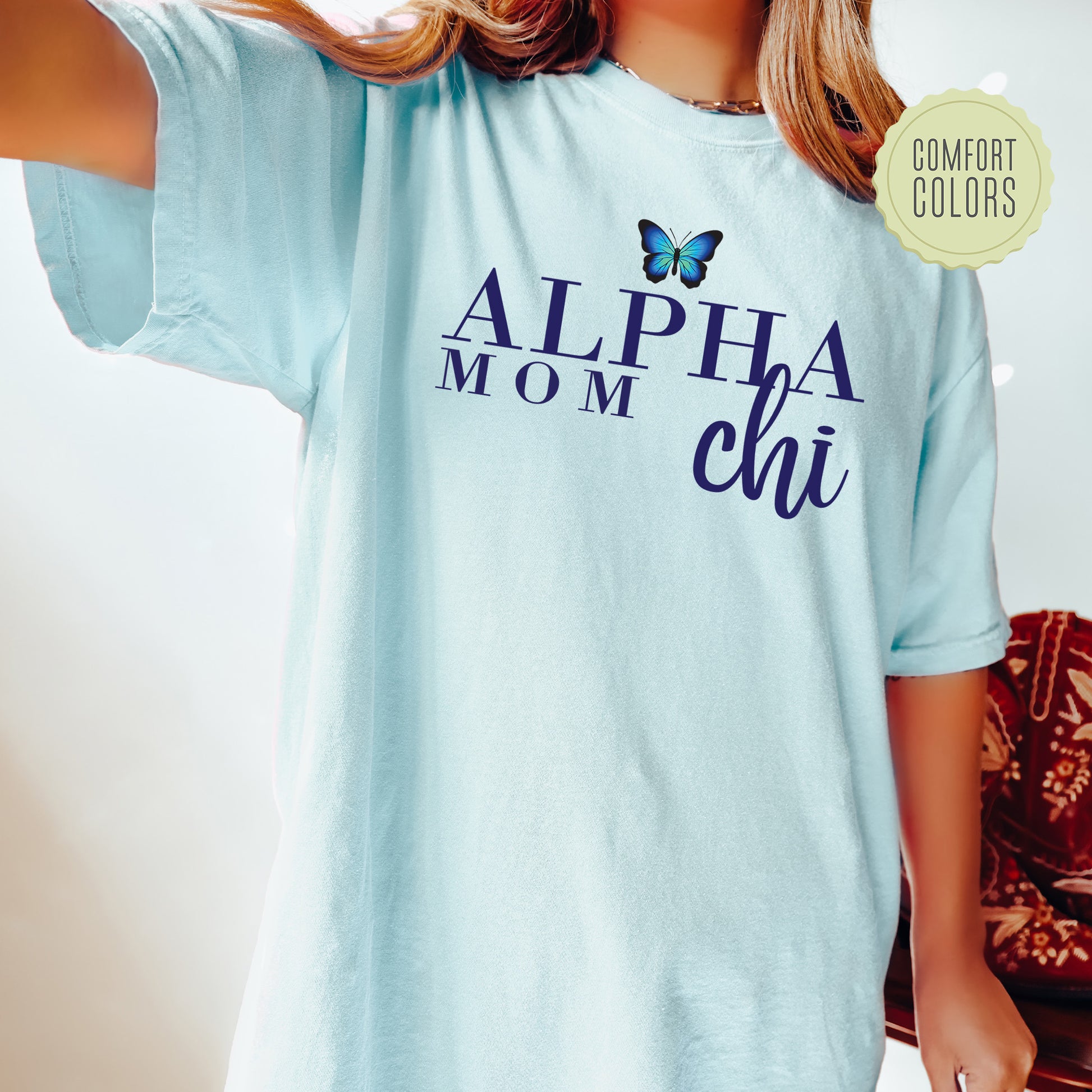 a woman wearing a blue shirt with a butterfly on it