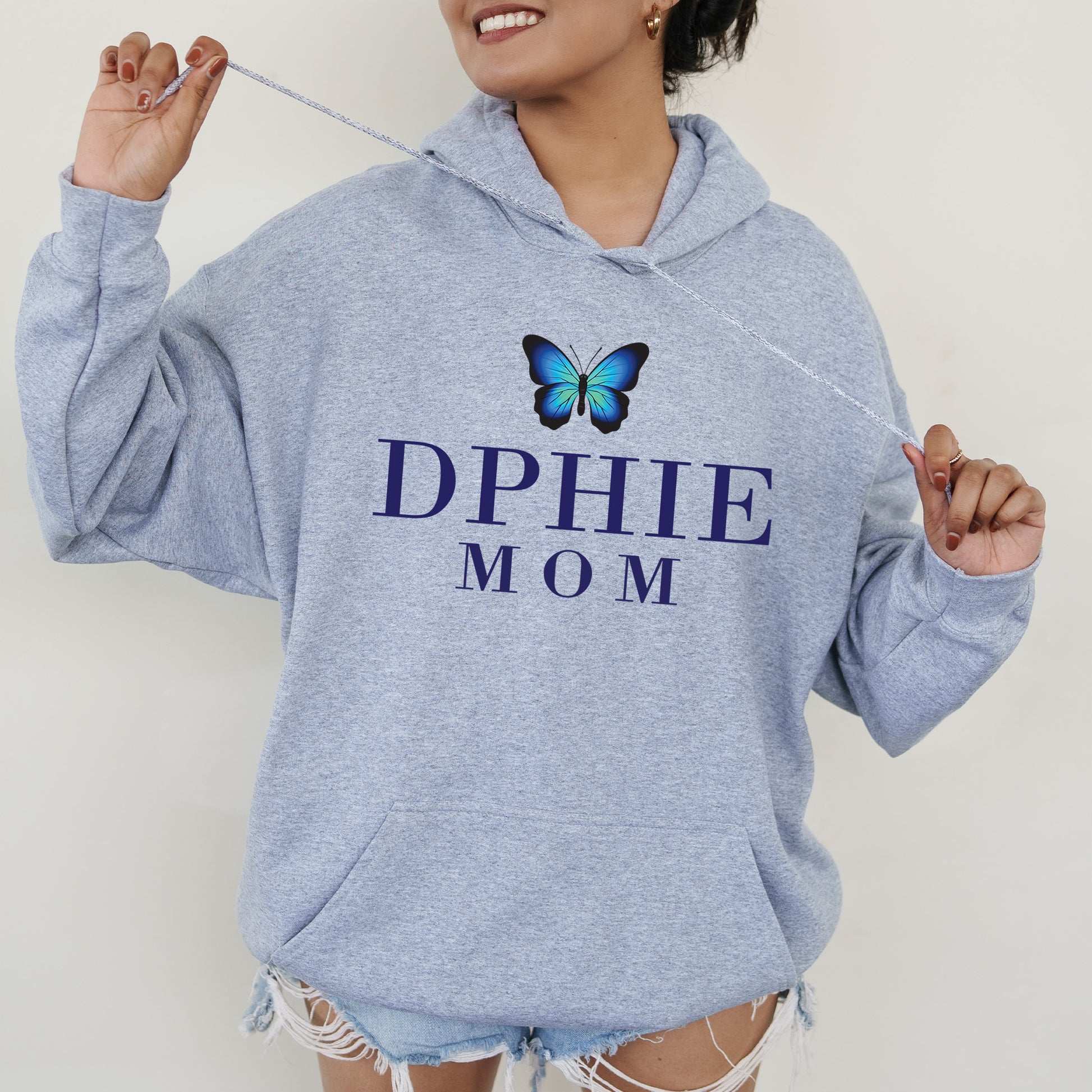 a woman wearing a blue sweatshirt with a butterfly on it