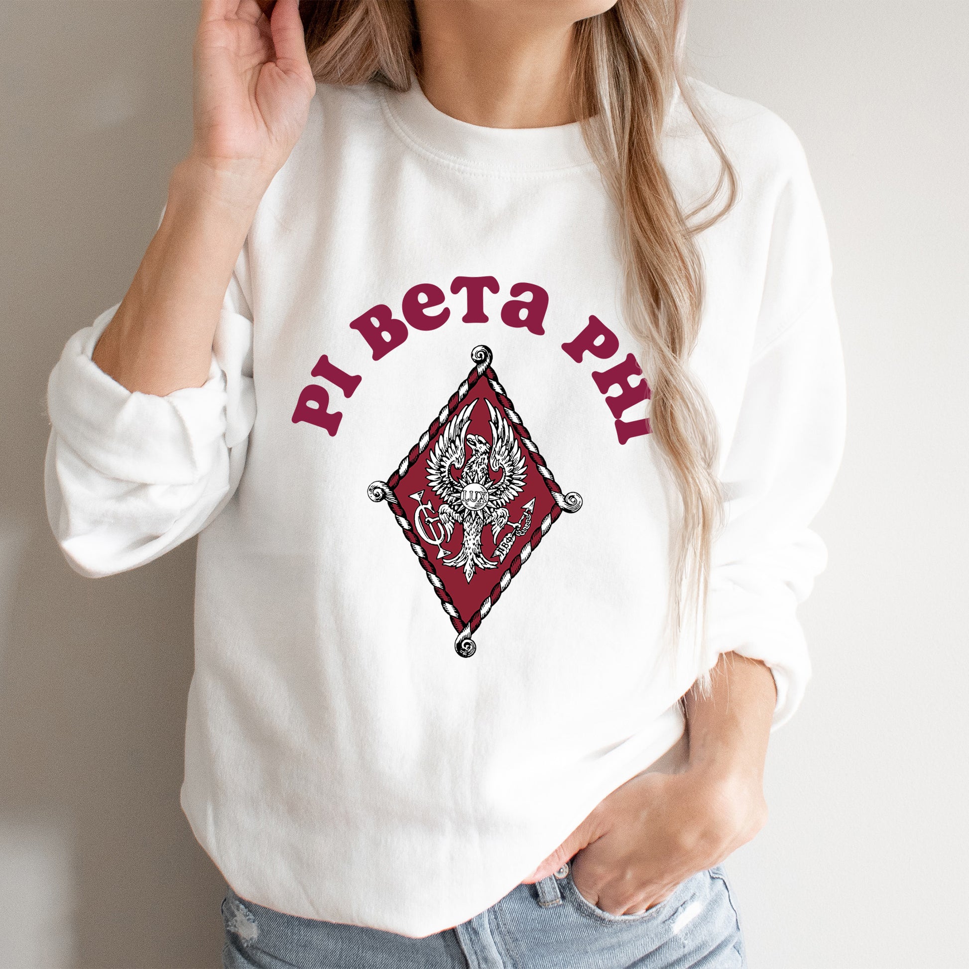 a woman wearing a white sweatshirt with a red design on it
