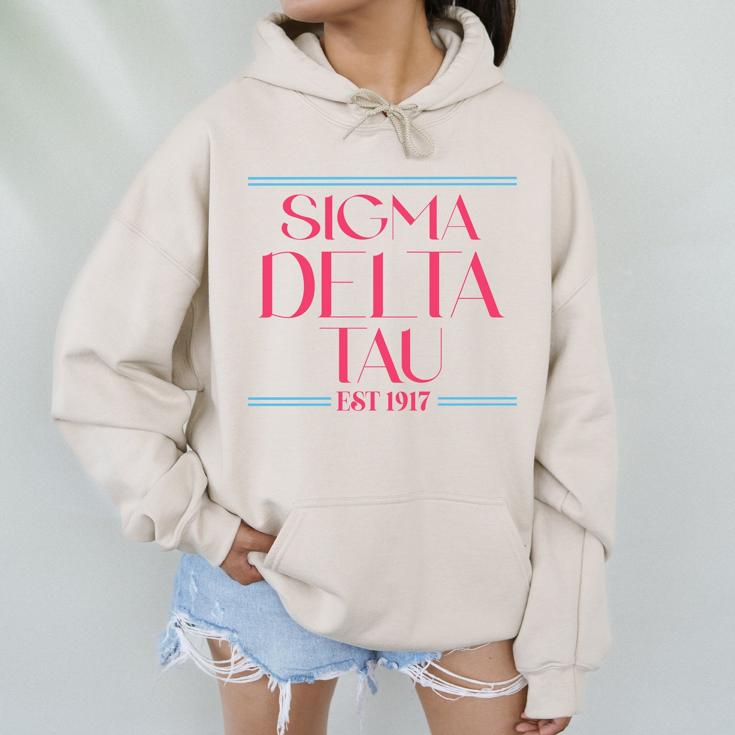 a woman wearing a sweatshirt with the slogan stigma delta tau