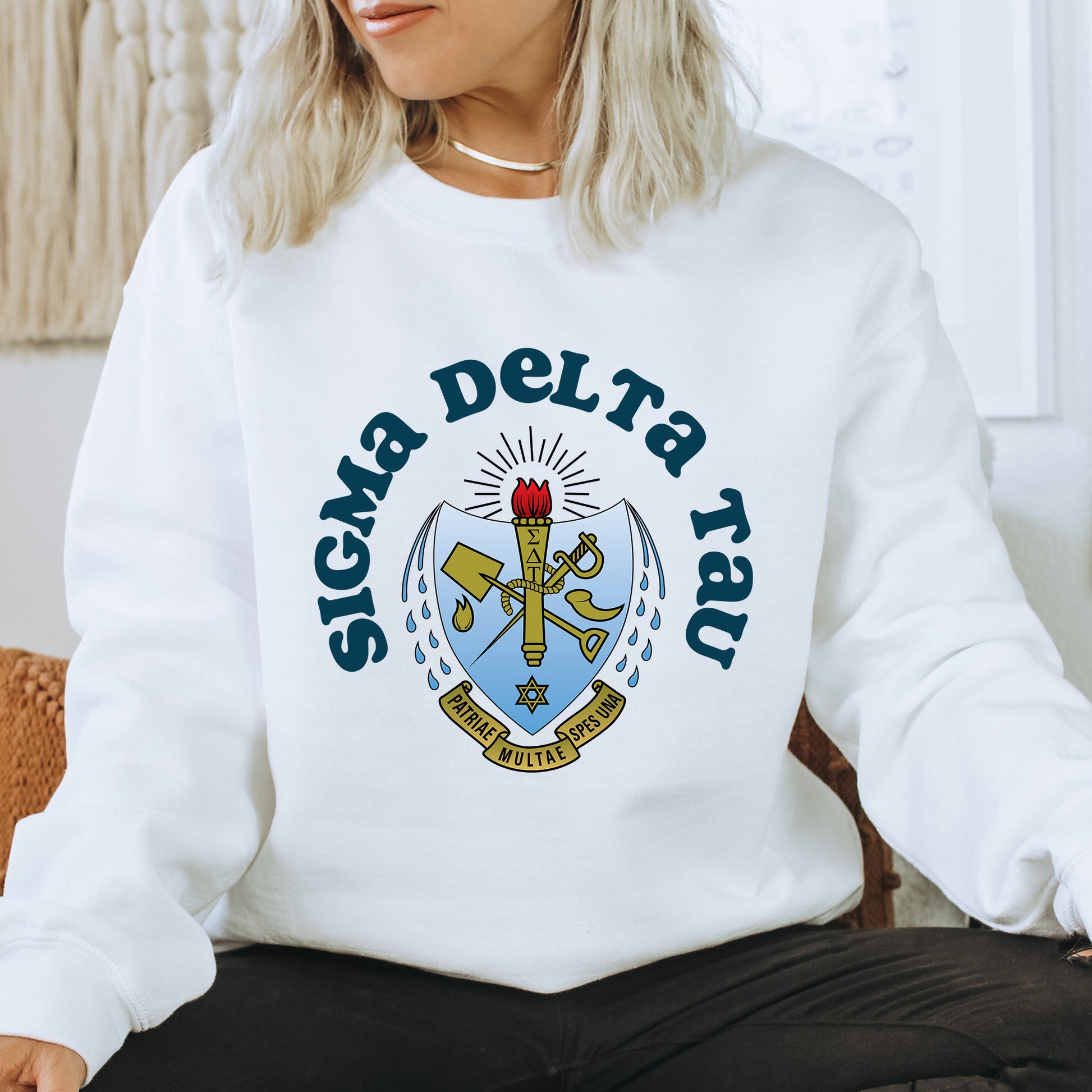a woman sitting on a chair wearing a white sweatshirt
