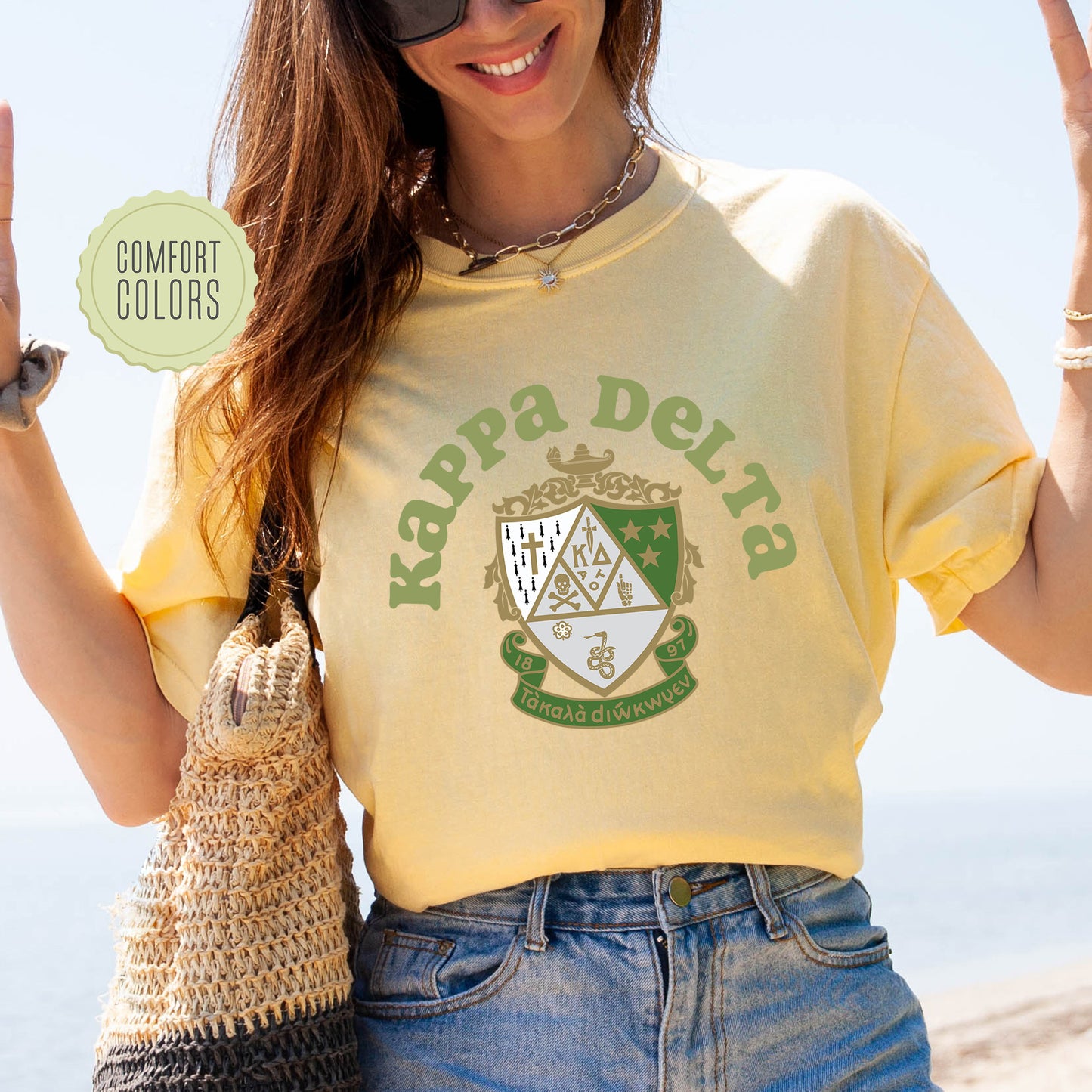 a woman in a yellow shirt holding up a peace sign