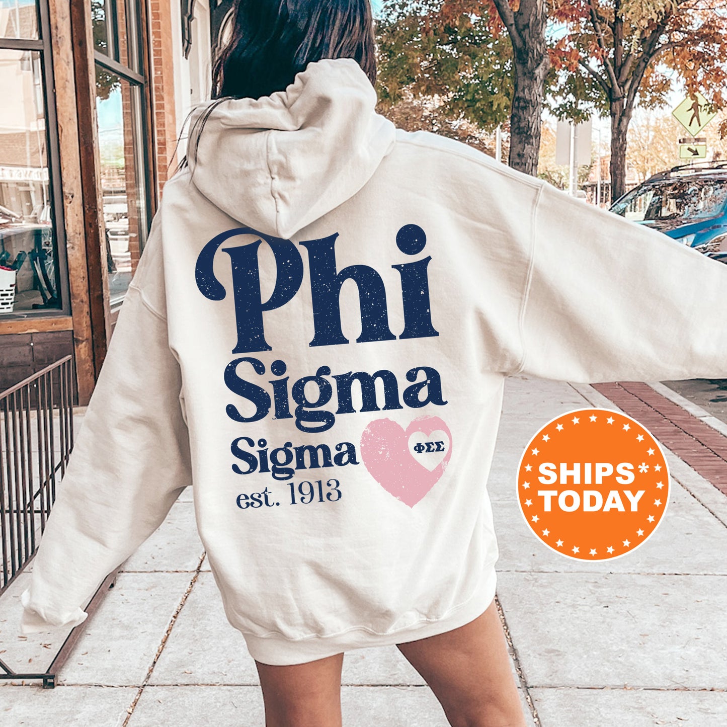a woman in a white hoodie is walking down the street