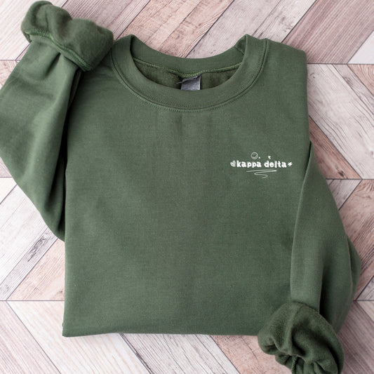a green sweatshirt with a white logo on it