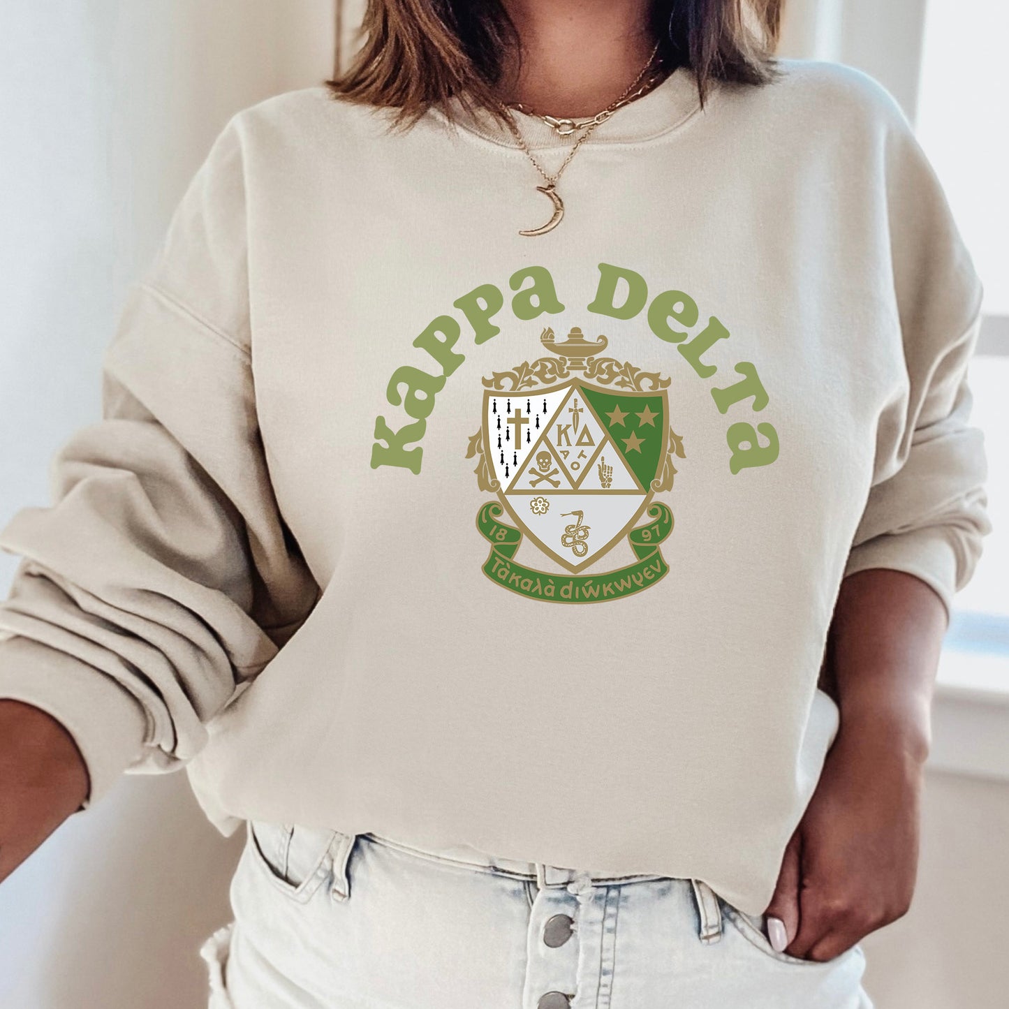 a woman wearing a sweatshirt with a crest on it