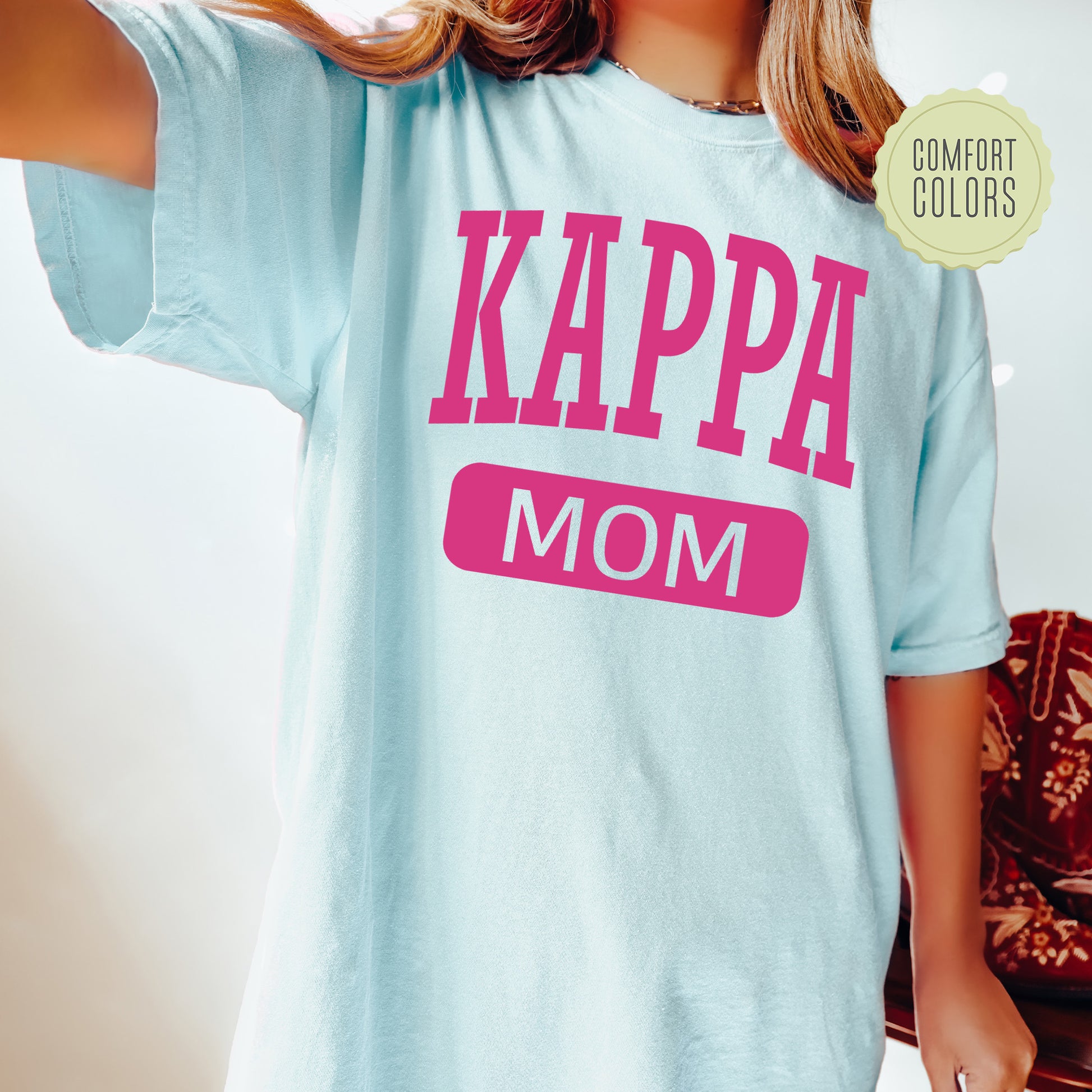 a woman wearing a t - shirt that says kappa mom