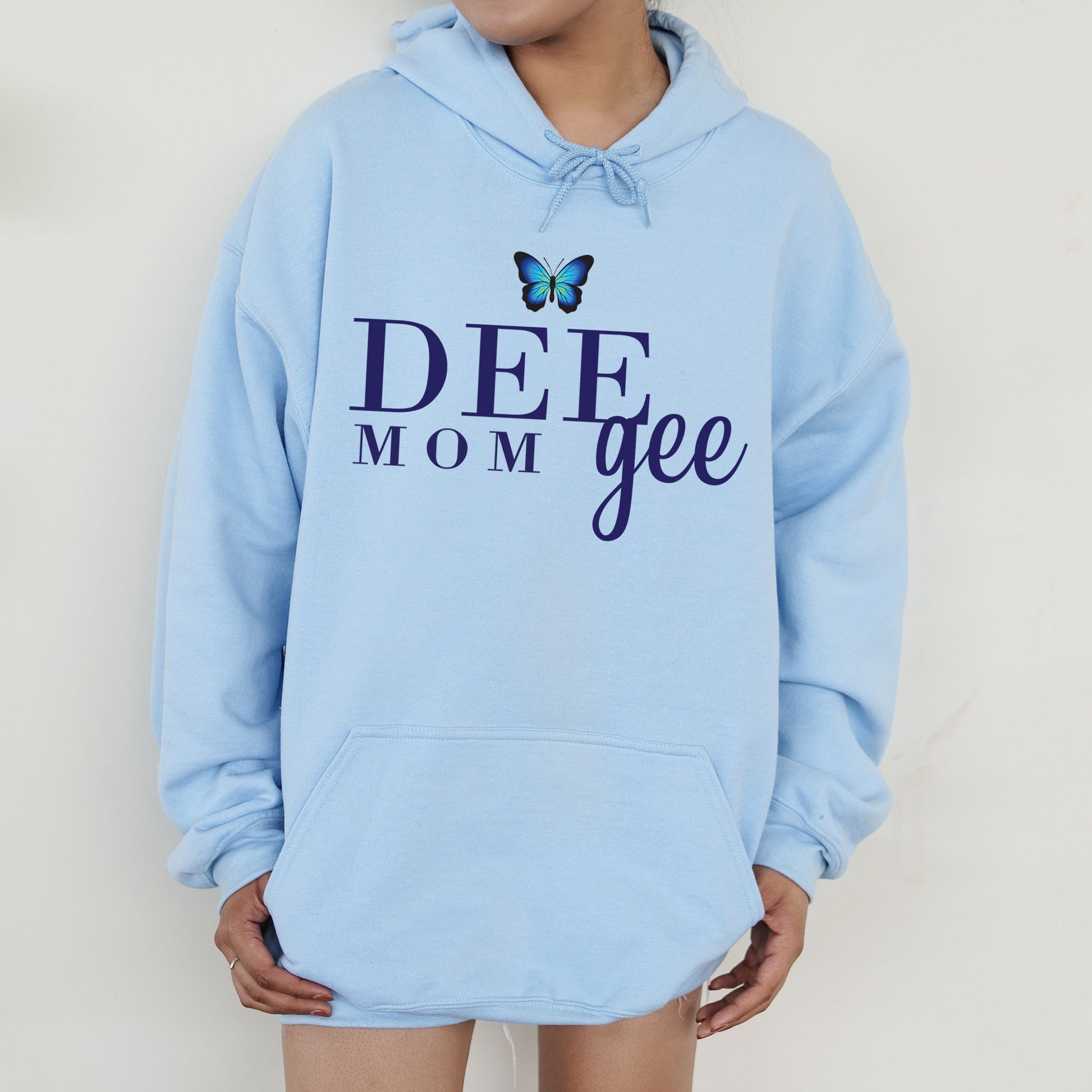 a woman wearing a blue hoodie with a butterfly on it