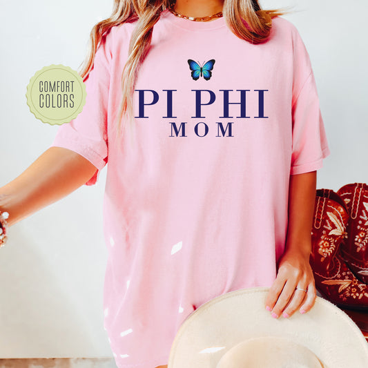 a woman wearing a pink shirt with a butterfly on it