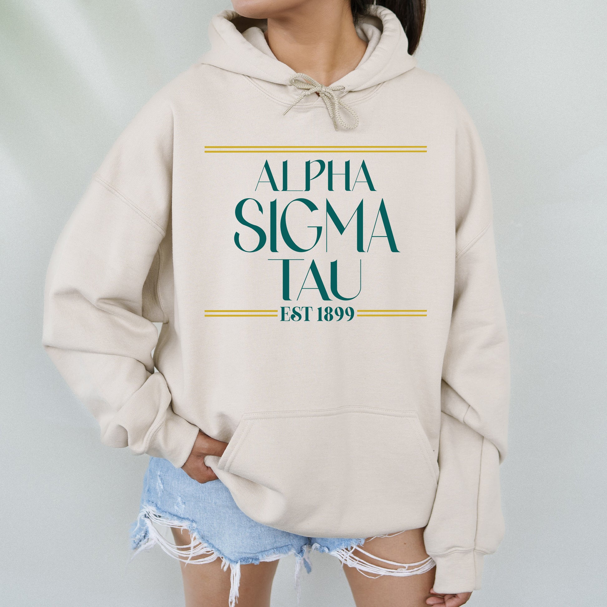 a woman wearing a white sweatshirt with a green and yellow logo