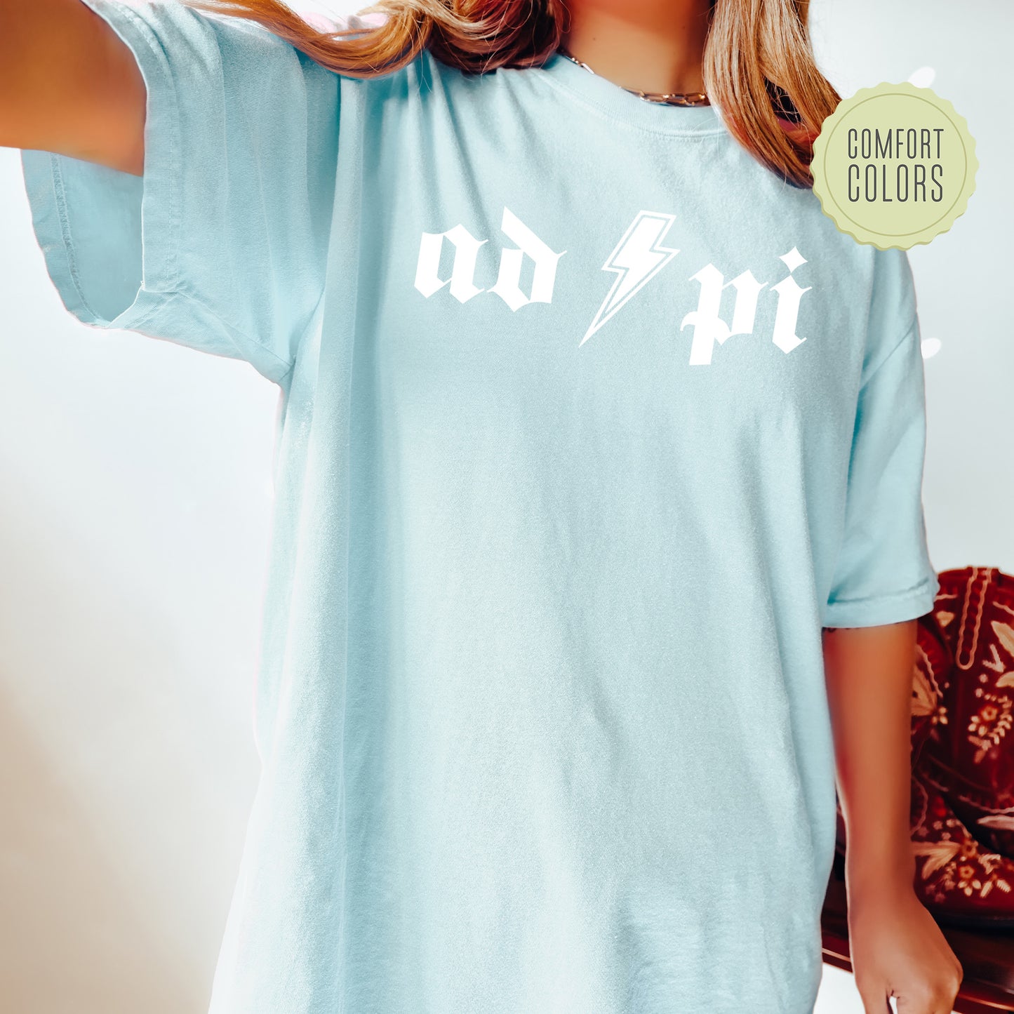 a woman wearing a blue shirt with a lightning bolt on it