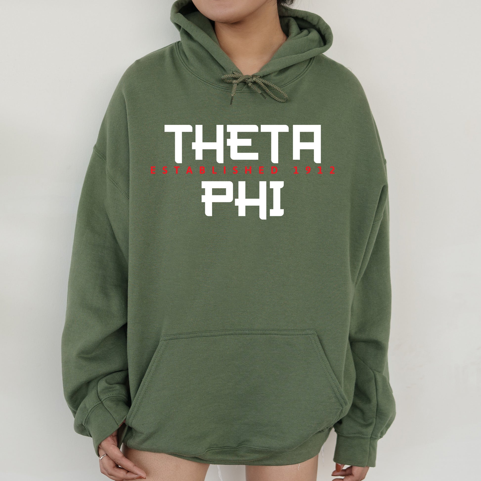 a person wearing a green hoodie with the words thera phh on it