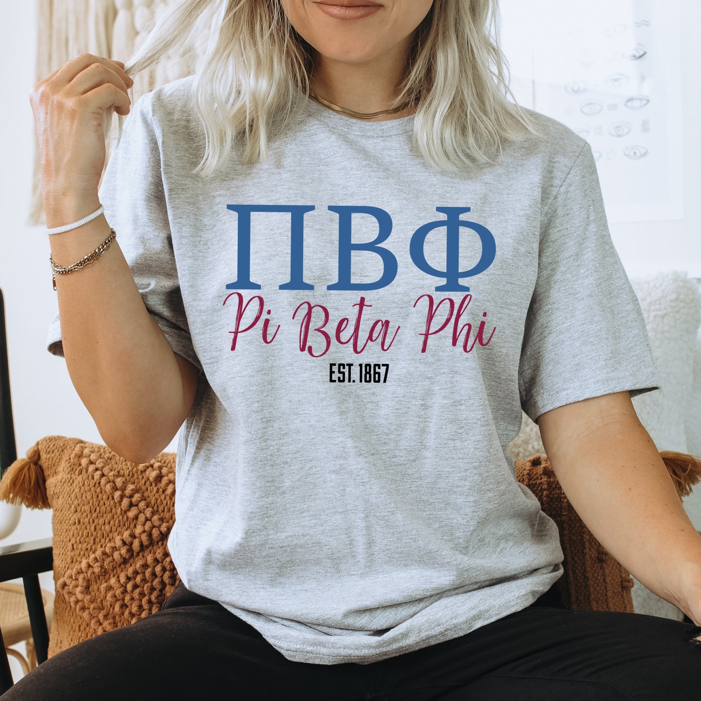 a woman sitting on a chair wearing a t - shirt