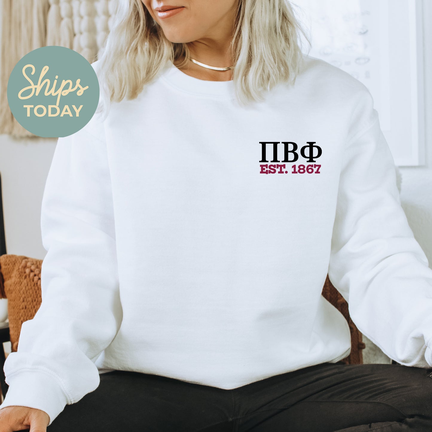 a woman sitting on a chair wearing a white sweatshirt