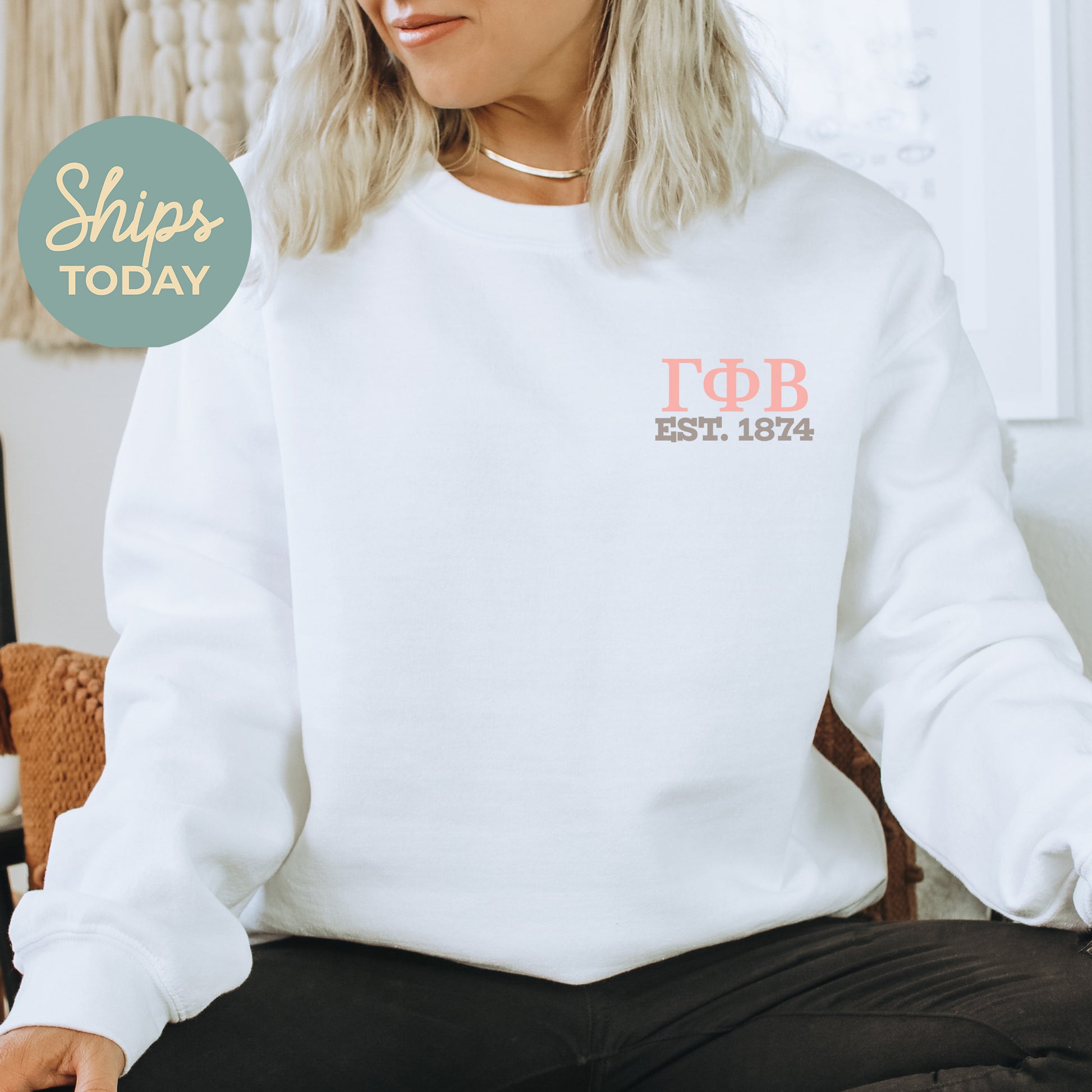 a woman sitting on a chair wearing a white sweatshirt