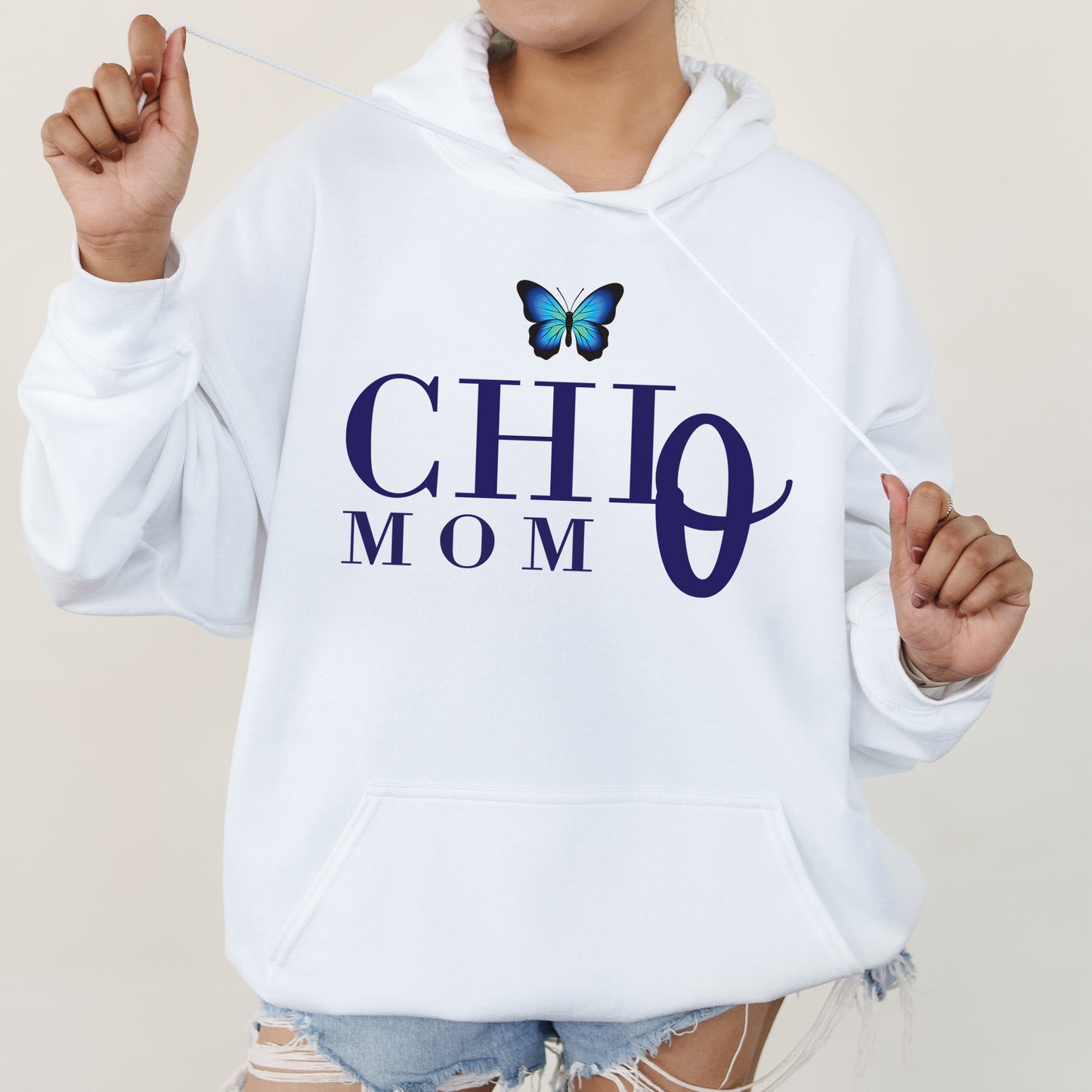 a woman wearing a white hoodie with a butterfly on it