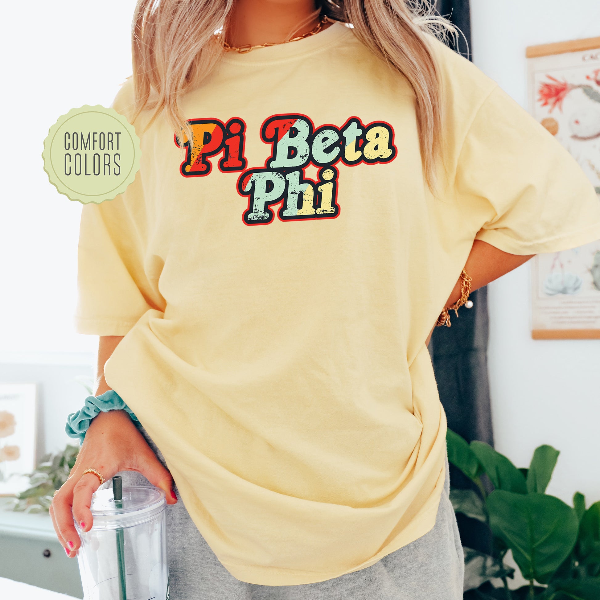 a woman in a yellow shirt holding a blender