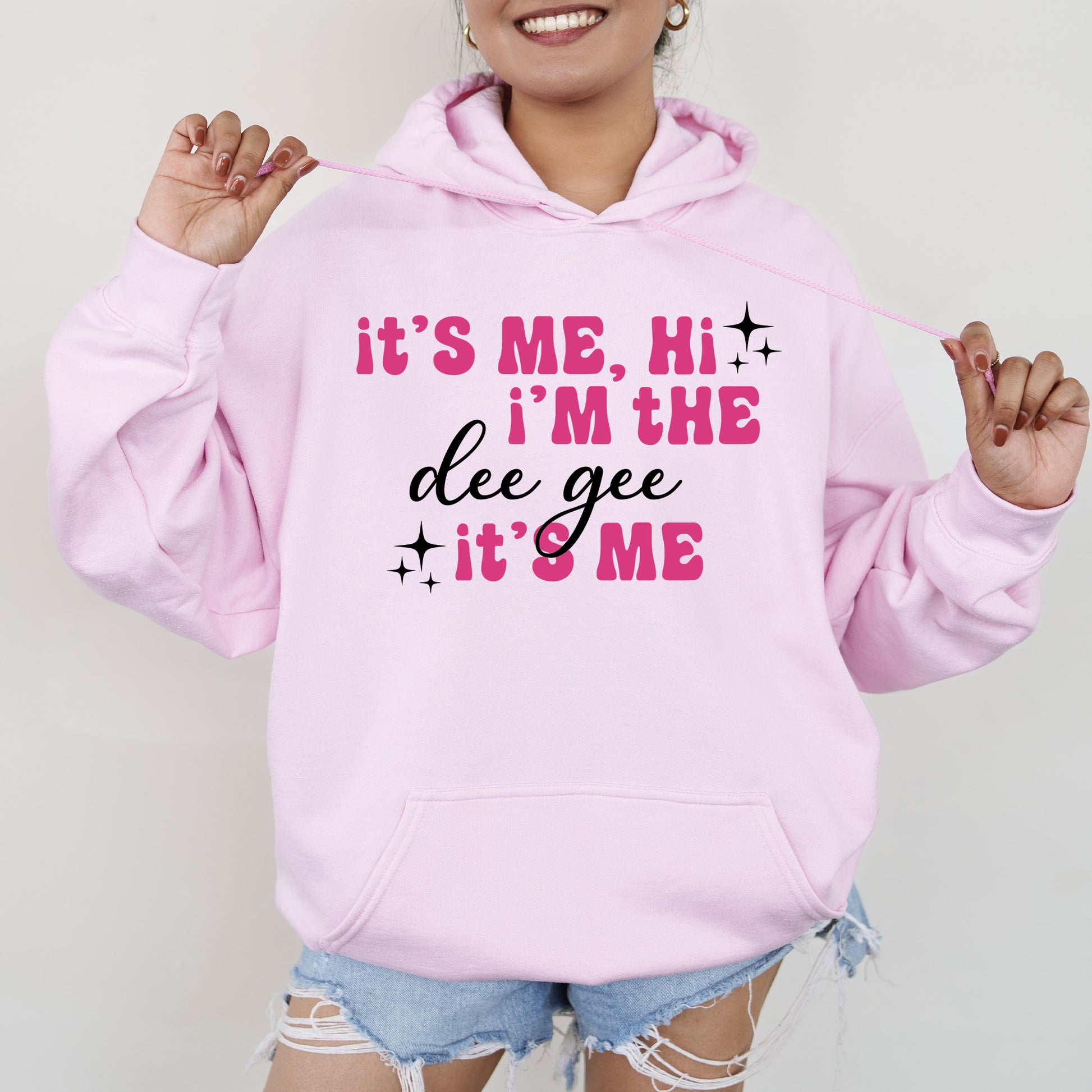 a woman wearing a pink hoodie that says it's me, i '