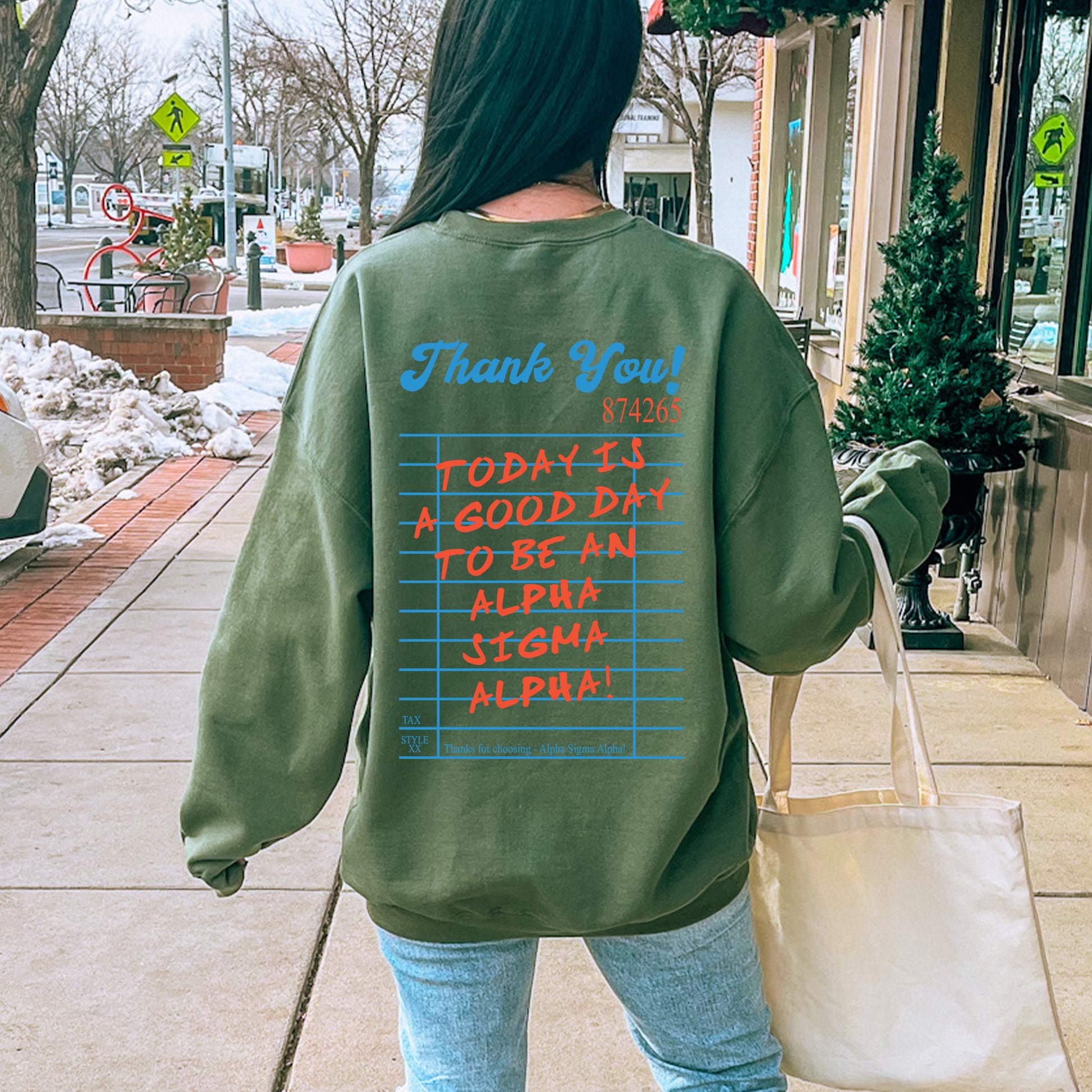 a woman walking down a sidewalk carrying a bag