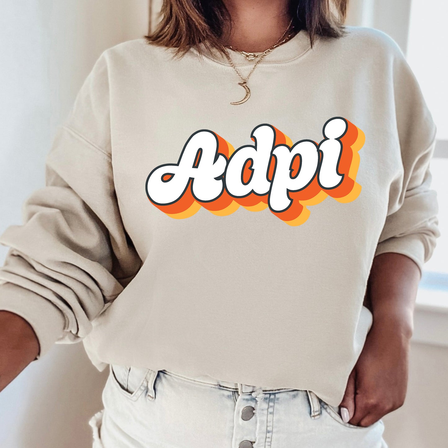 a woman wearing a sweatshirt with the word adpi printed on it