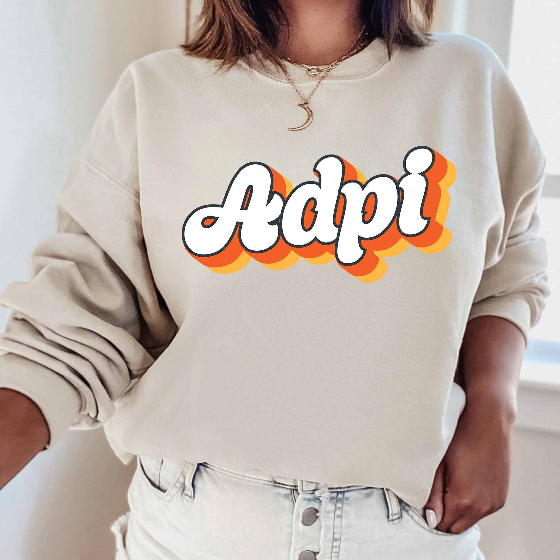 a woman wearing a sweatshirt with the word adpi printed on it