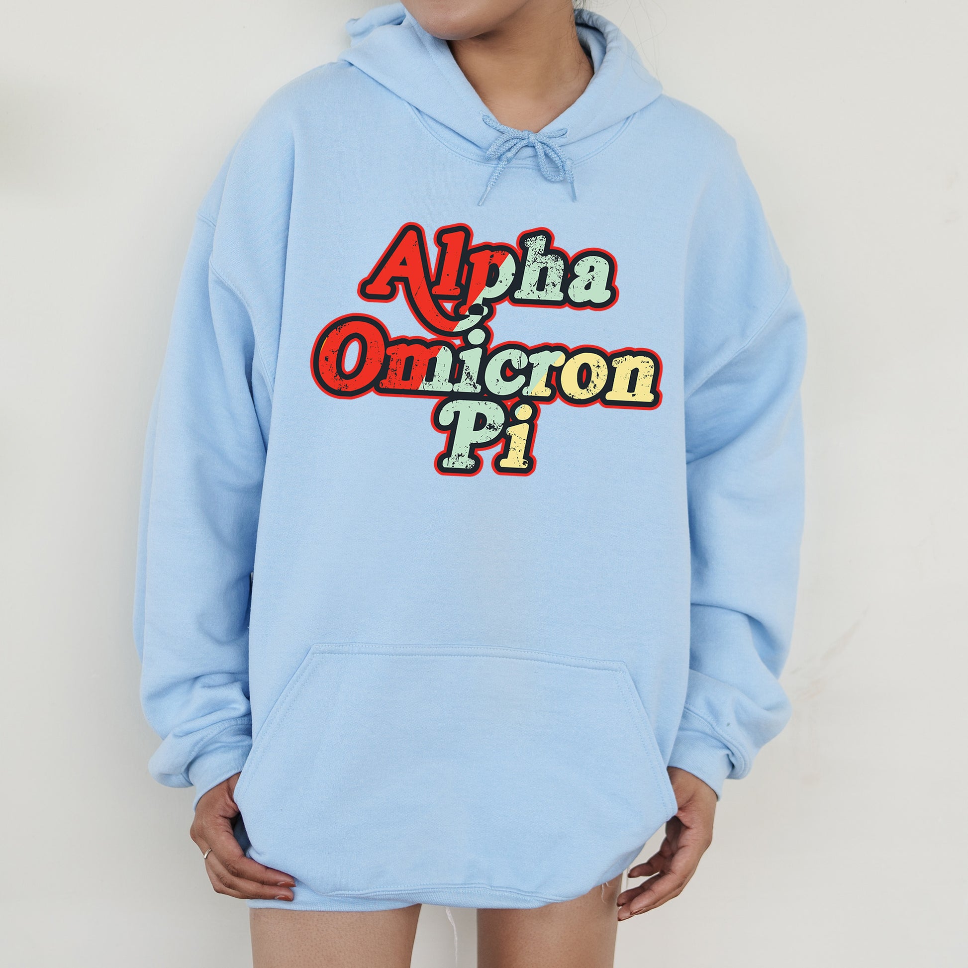 a person wearing a blue hoodie with the words aha omricon pi