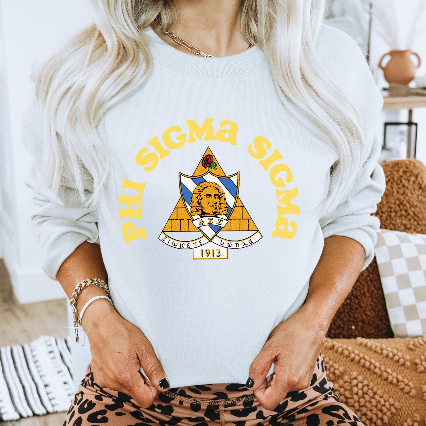 a woman wearing a white sweatshirt and leopard print pants