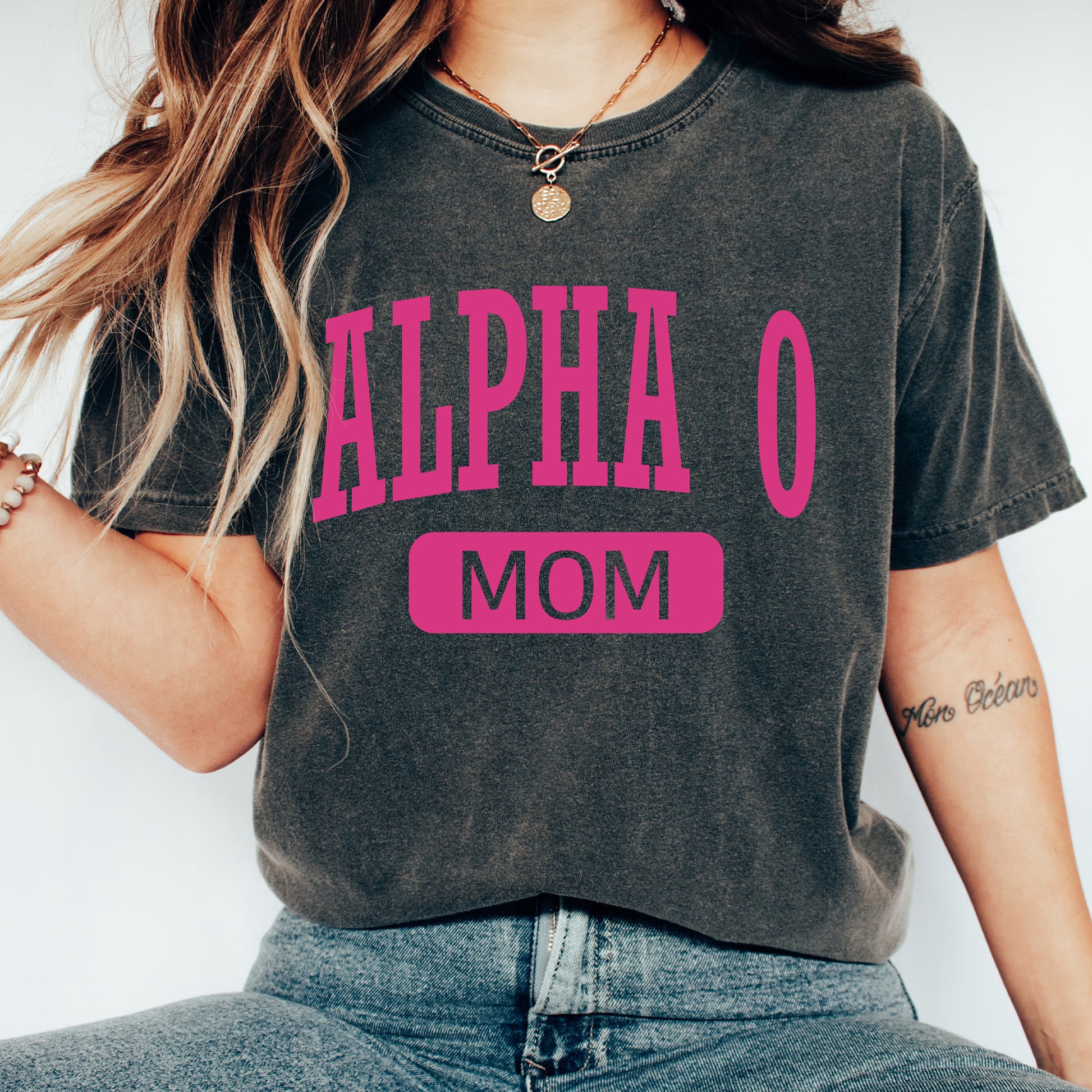 a woman wearing a black shirt with pink letters on it