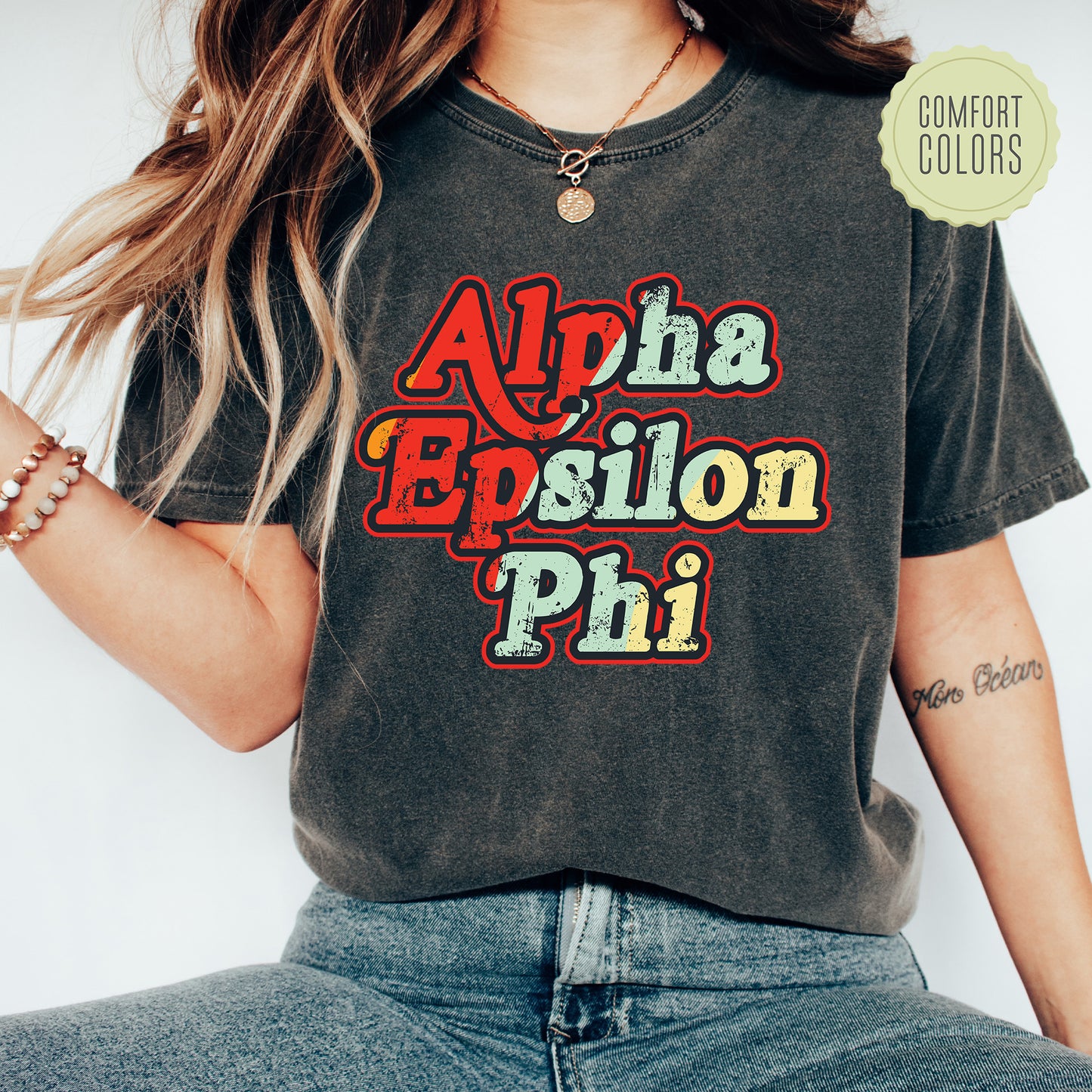 a woman wearing a black shirt with the words aloha esilon phi