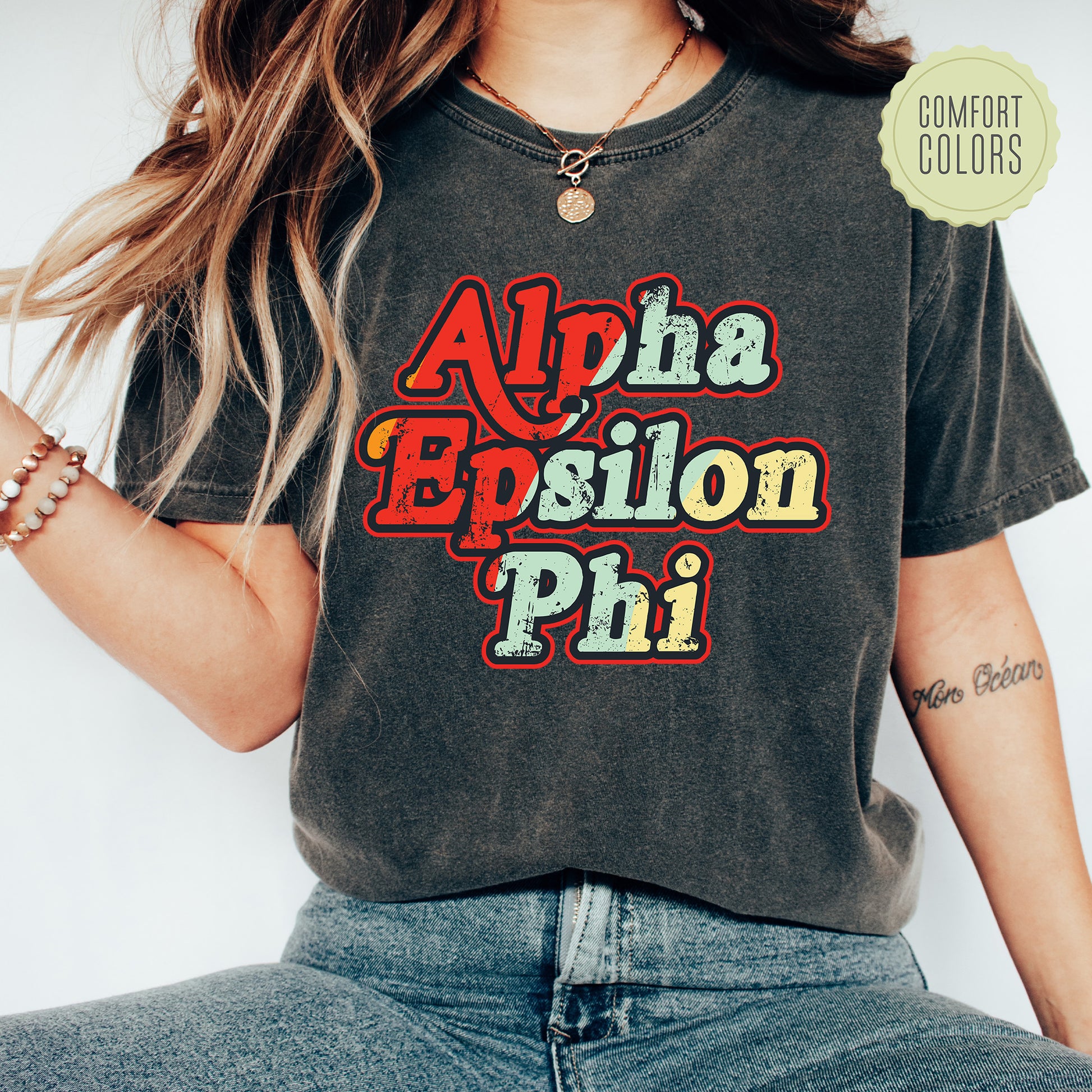 a woman wearing a black shirt with the words aloha esilon phi