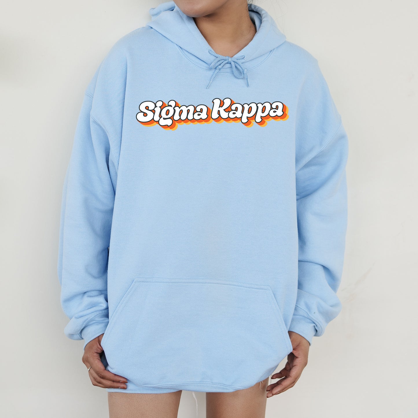 a person wearing a blue hoodie with the word stigma kapp on it