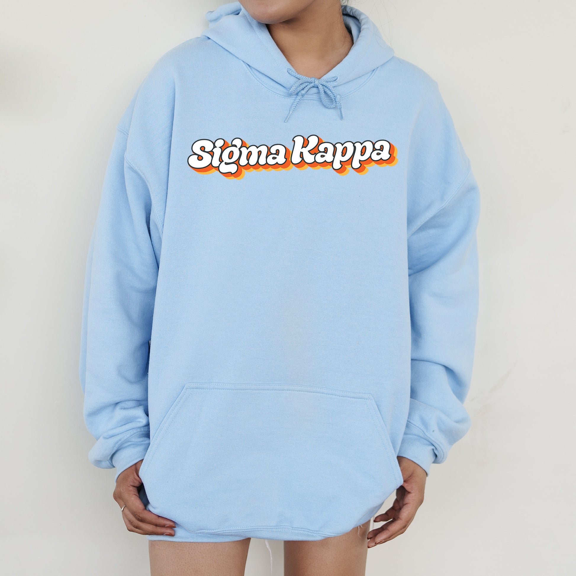 a person wearing a blue hoodie with the word stigma kapp on it