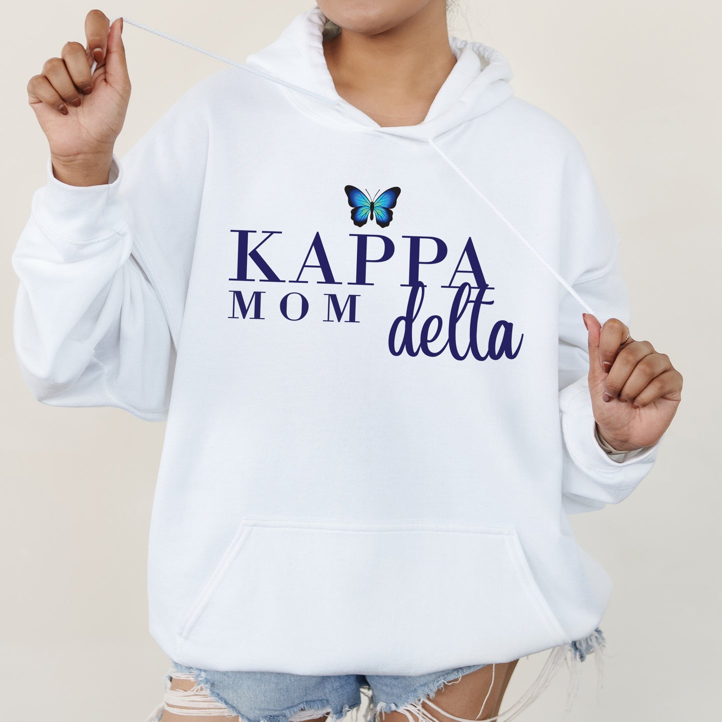 a woman wearing a white hoodie with a butterfly on it