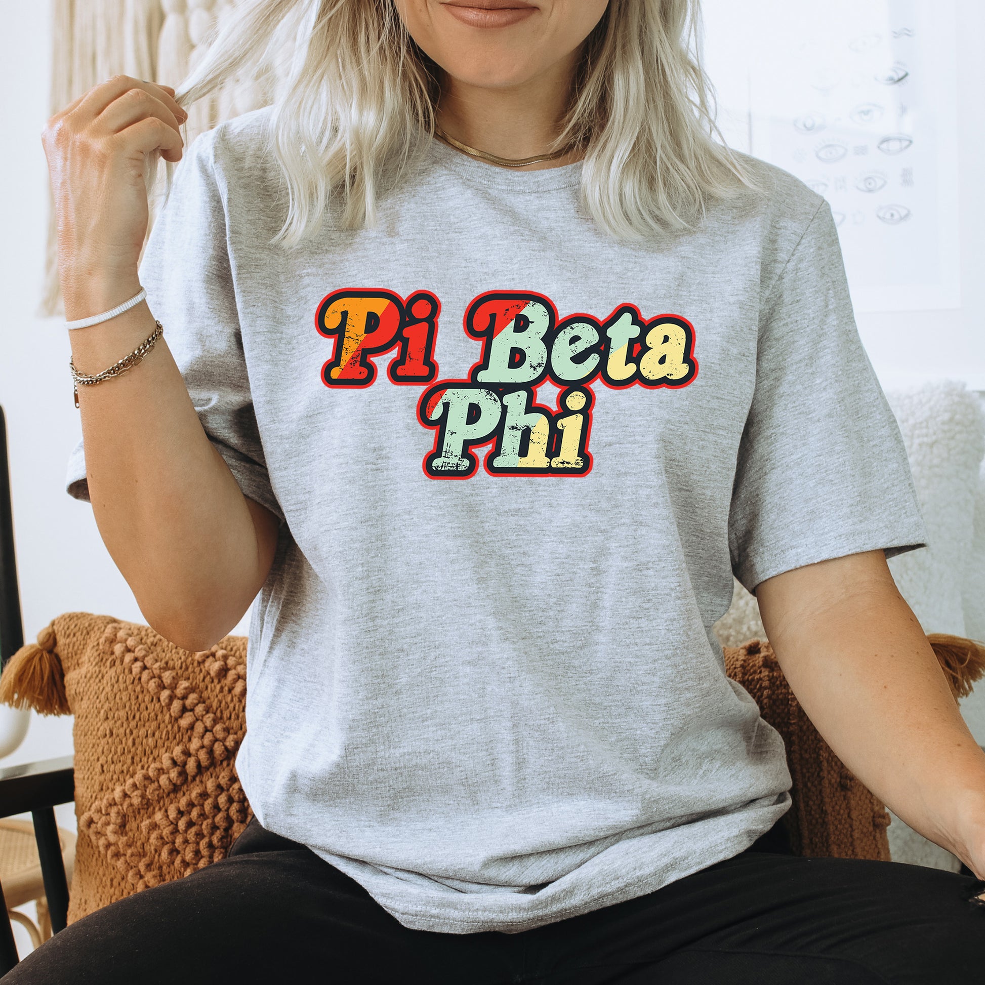 a woman sitting on a chair wearing a pi peta phi shirt