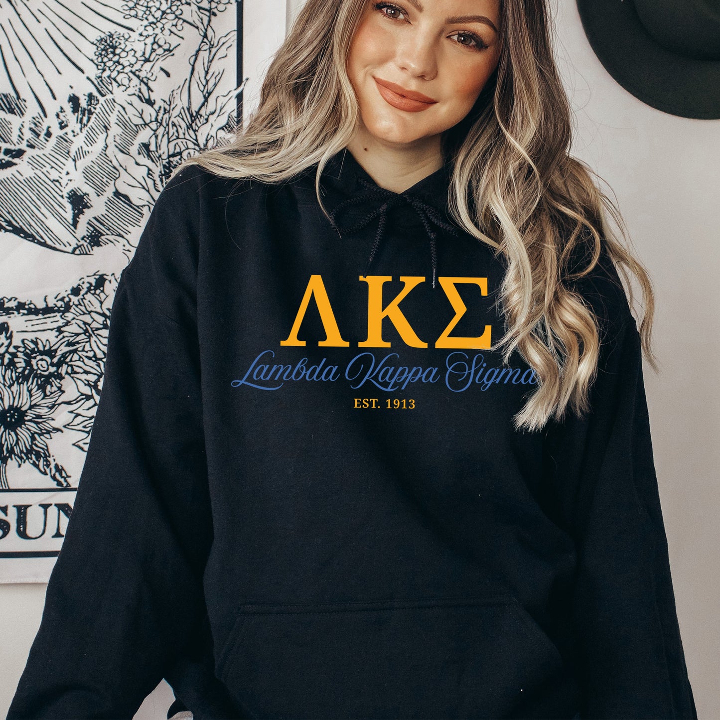 a woman wearing a black hoodie with the letters ake on it