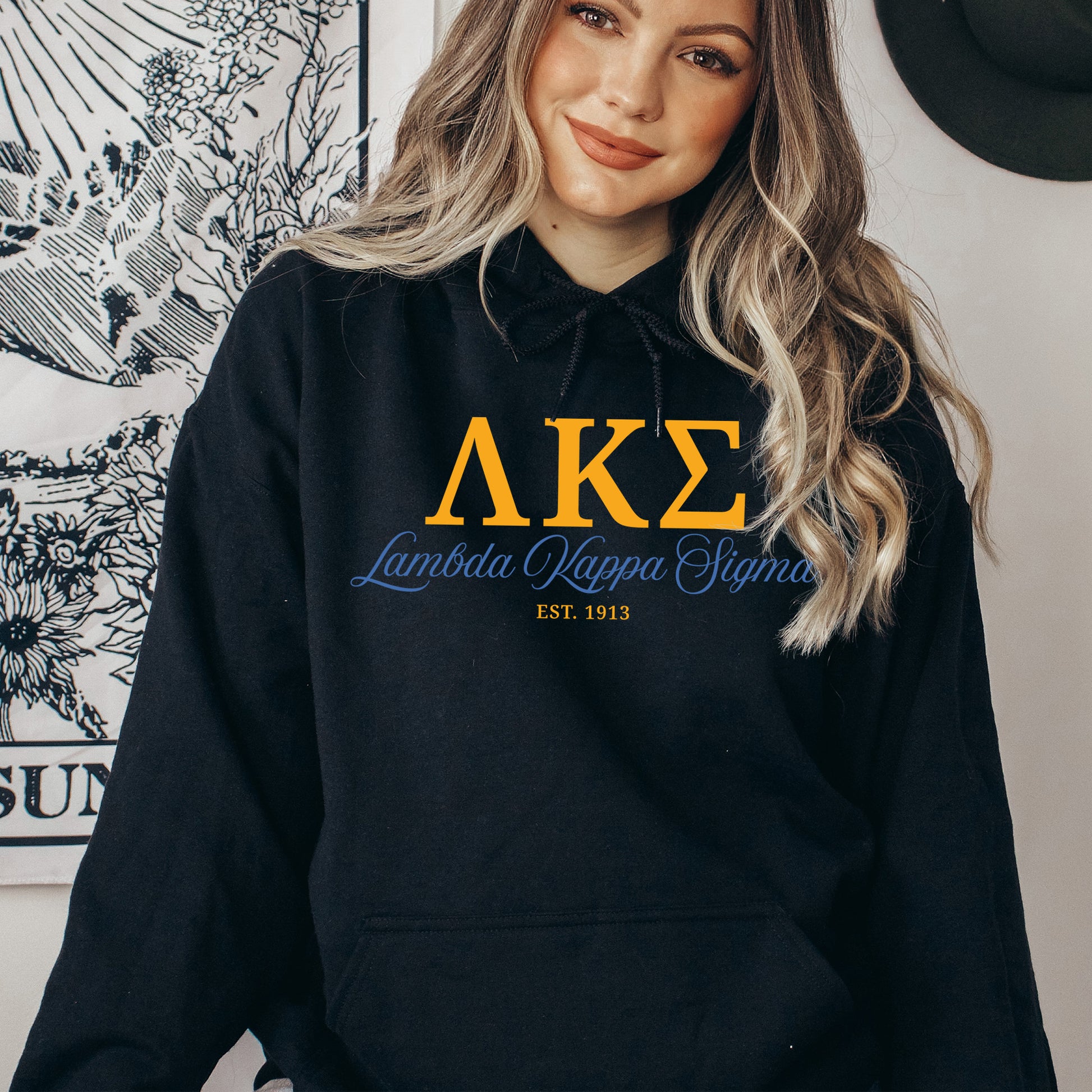 a woman wearing a black hoodie with the letters ake on it