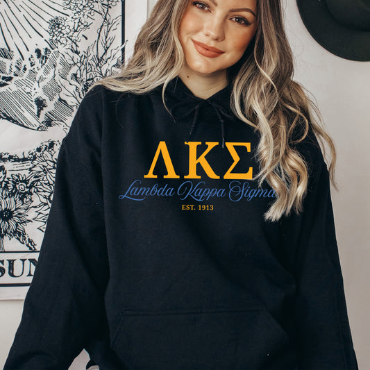 a woman wearing a black hoodie with the letters ake on it