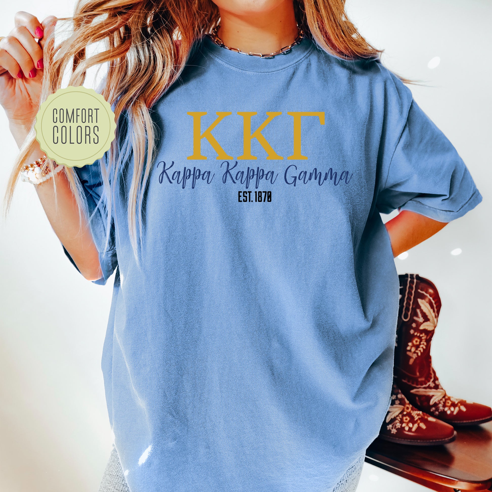 a woman wearing a blue t - shirt with the words kkt on it