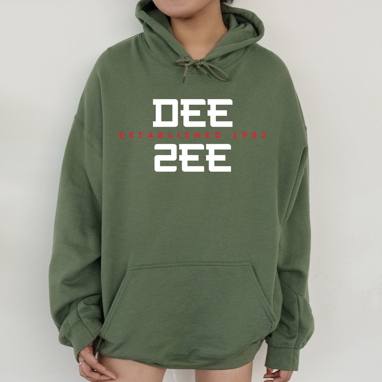 a person wearing a green hoodie with the words dee on it
