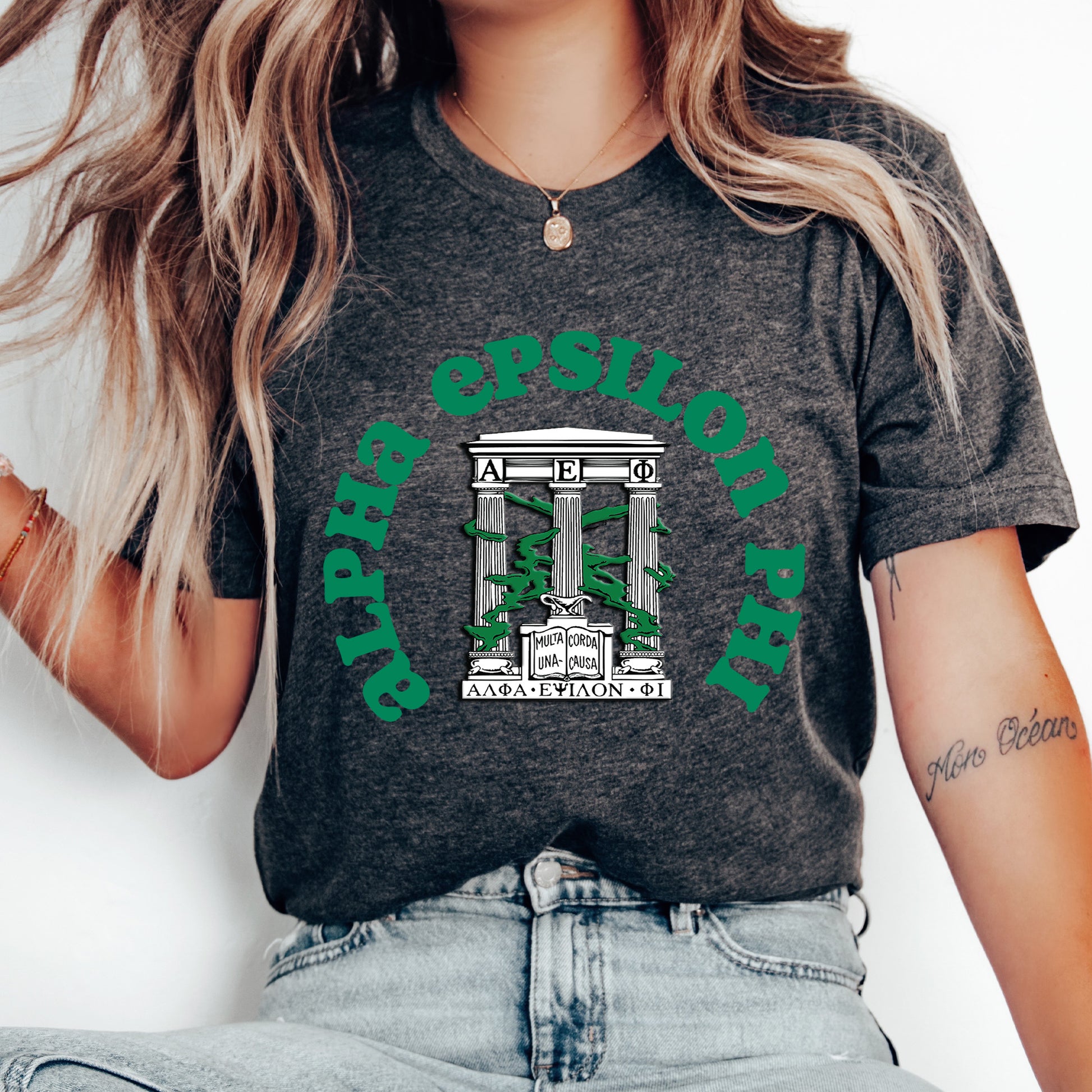 a woman wearing a black shirt with a green logo on it