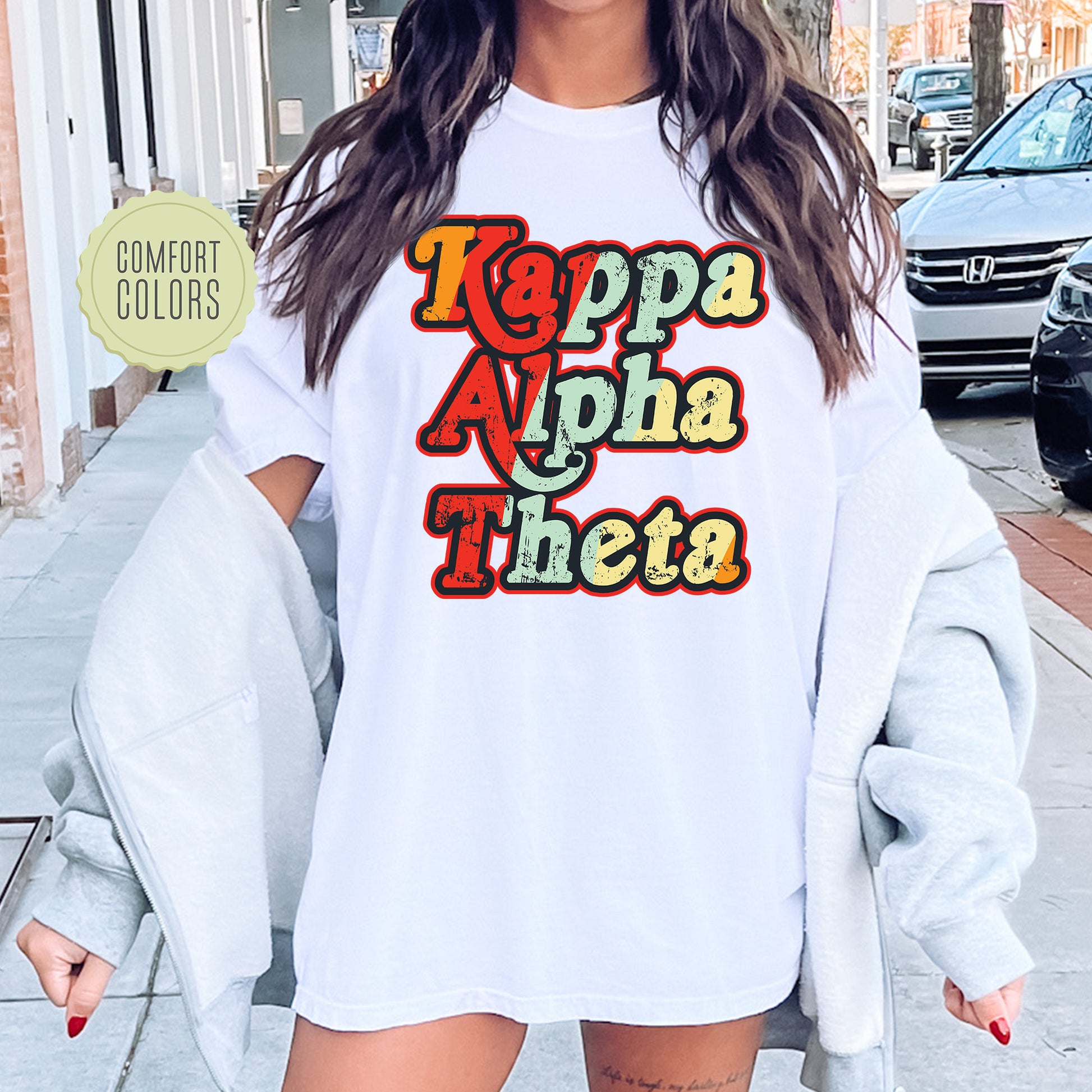 a woman wearing a white t - shirt that says kappa apha tho