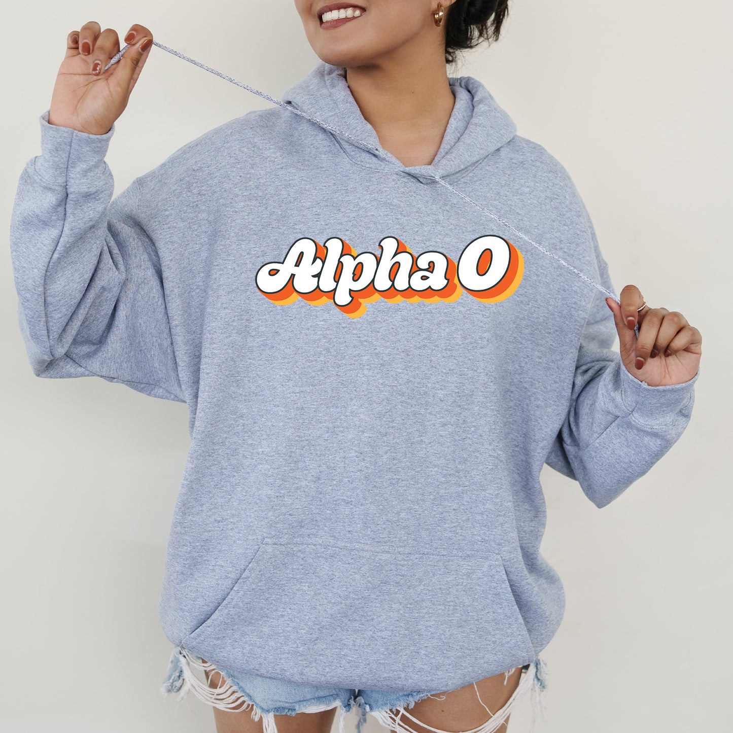 a woman in a blue hoodie holding a toothbrush