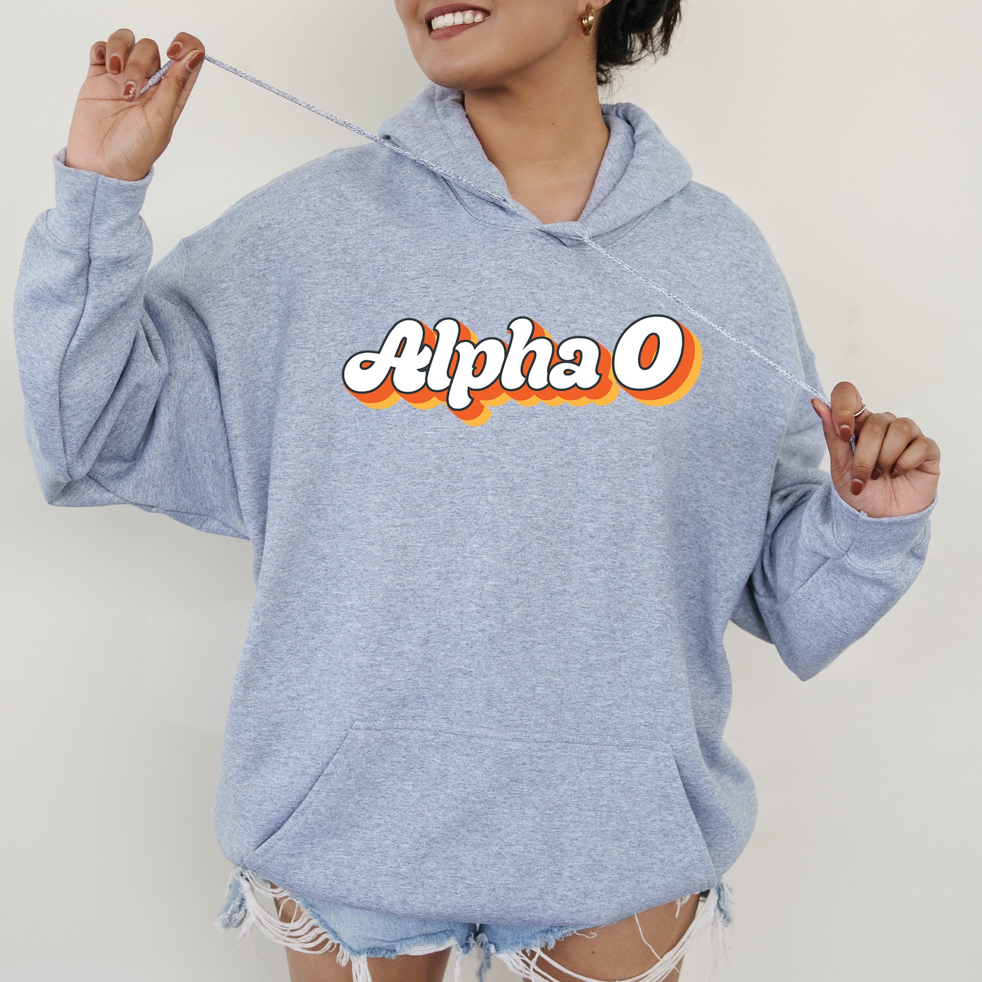 a woman in a blue hoodie holding a toothbrush