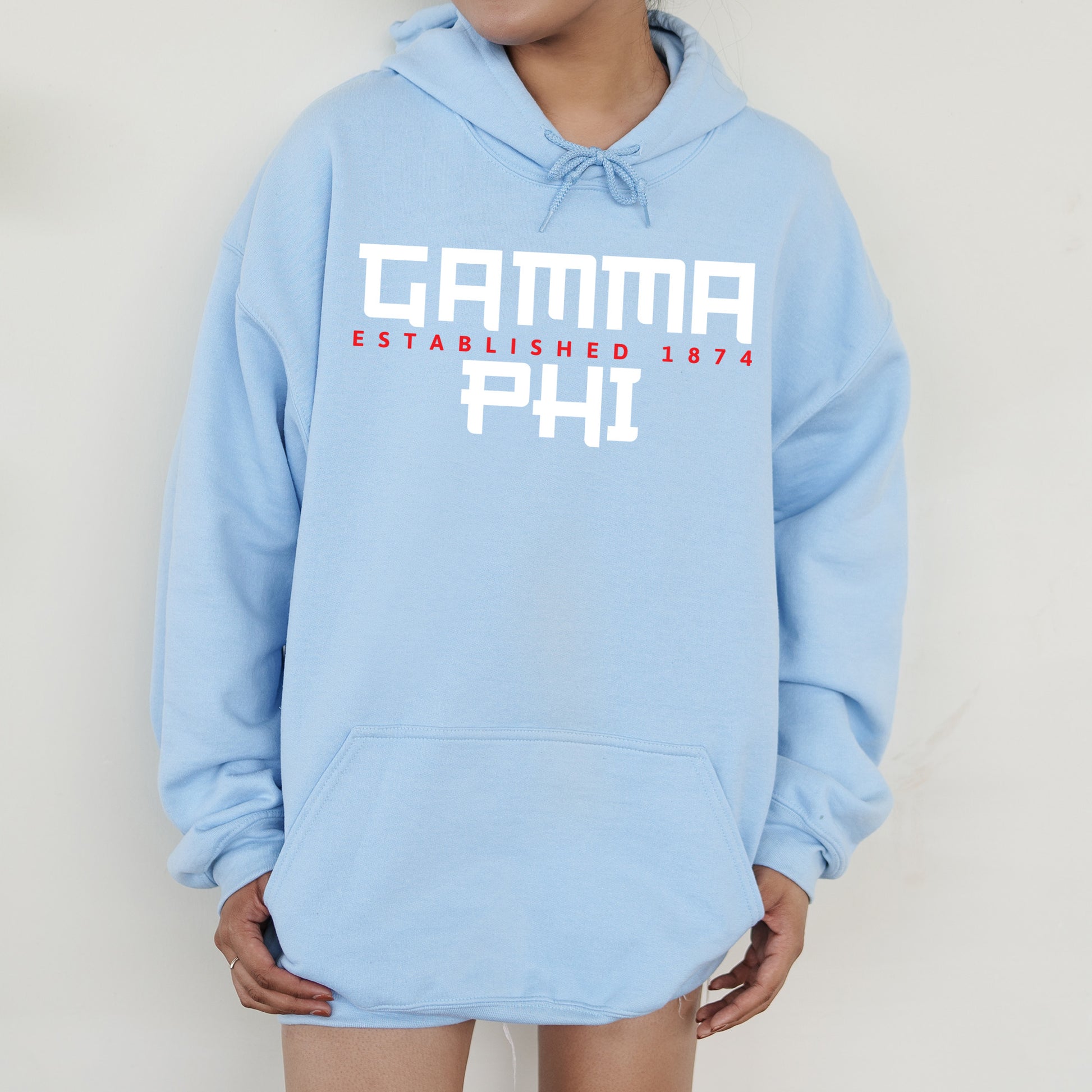 a person wearing a blue hoodie with the words garma established in red and