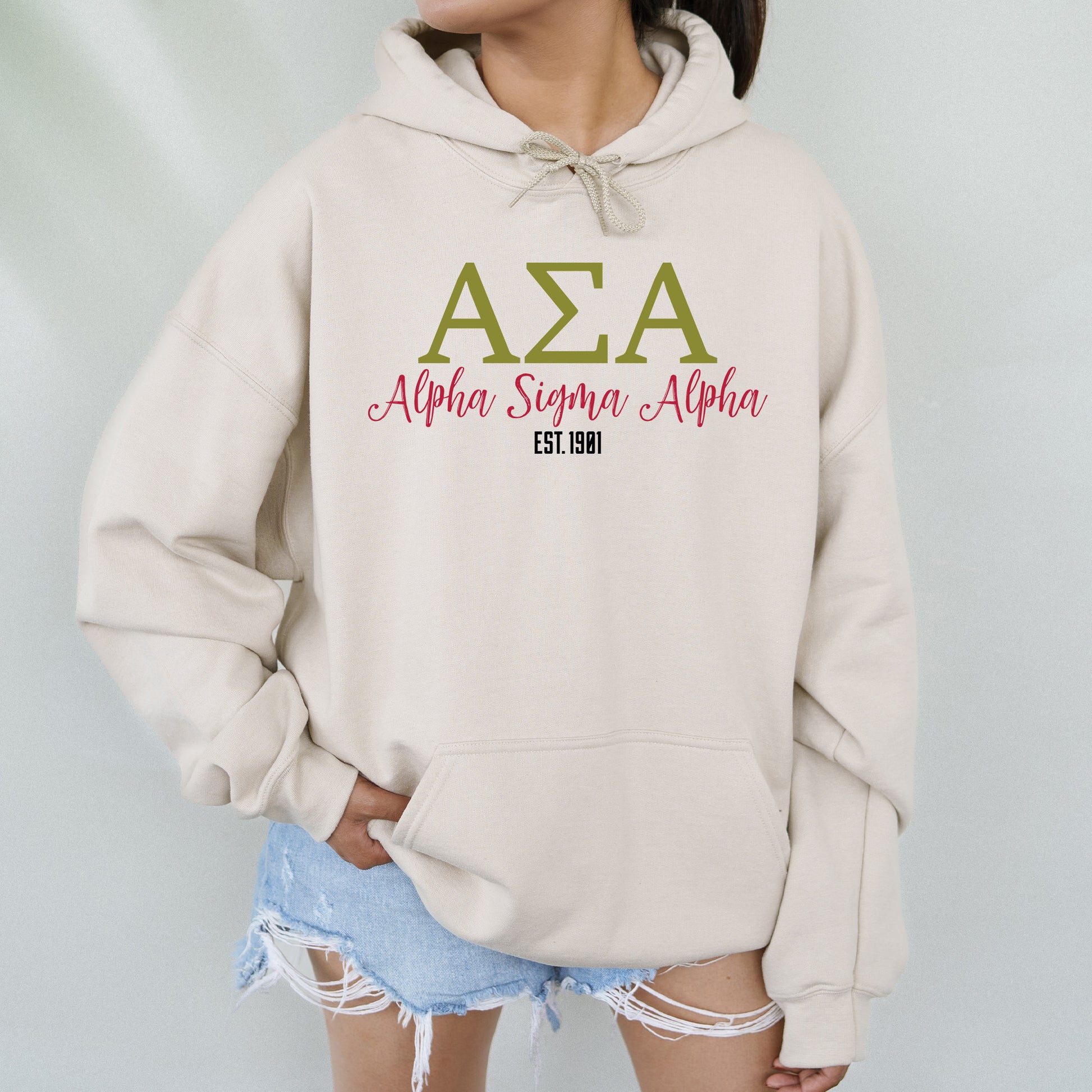 a woman wearing a white hoodie with the word aza on it